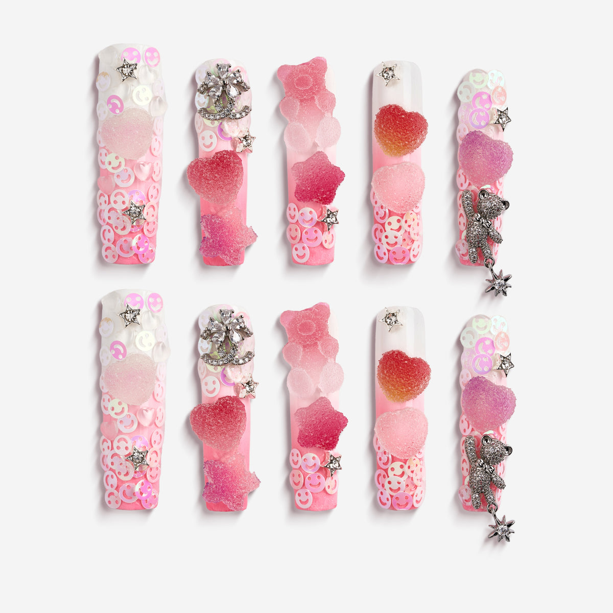 Playful 3D gummy bear press on nails with sugar heart accents and charms. Y2K inspired and reusable.