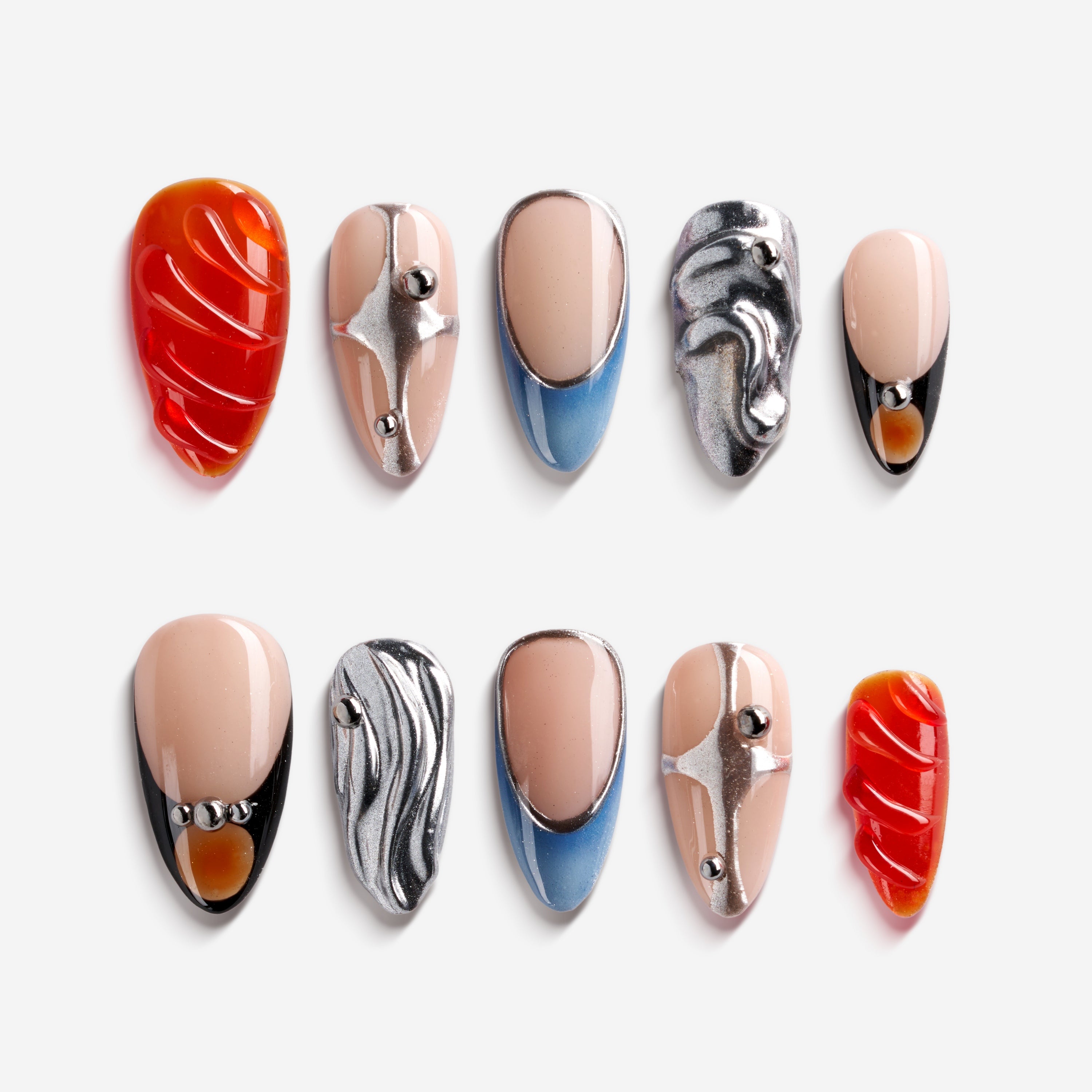 Modern almond press on nails with silver chrome accents and cool nude base. Sleek, glossy and reusable.