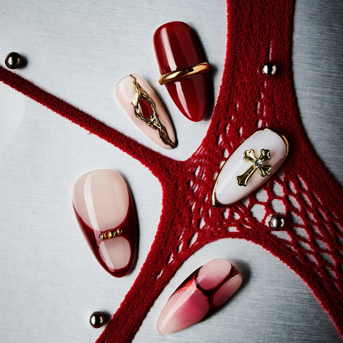 Bold red coffin press on nails with gold cross accents and gradient finish. Dramatic, elegant and reusable.