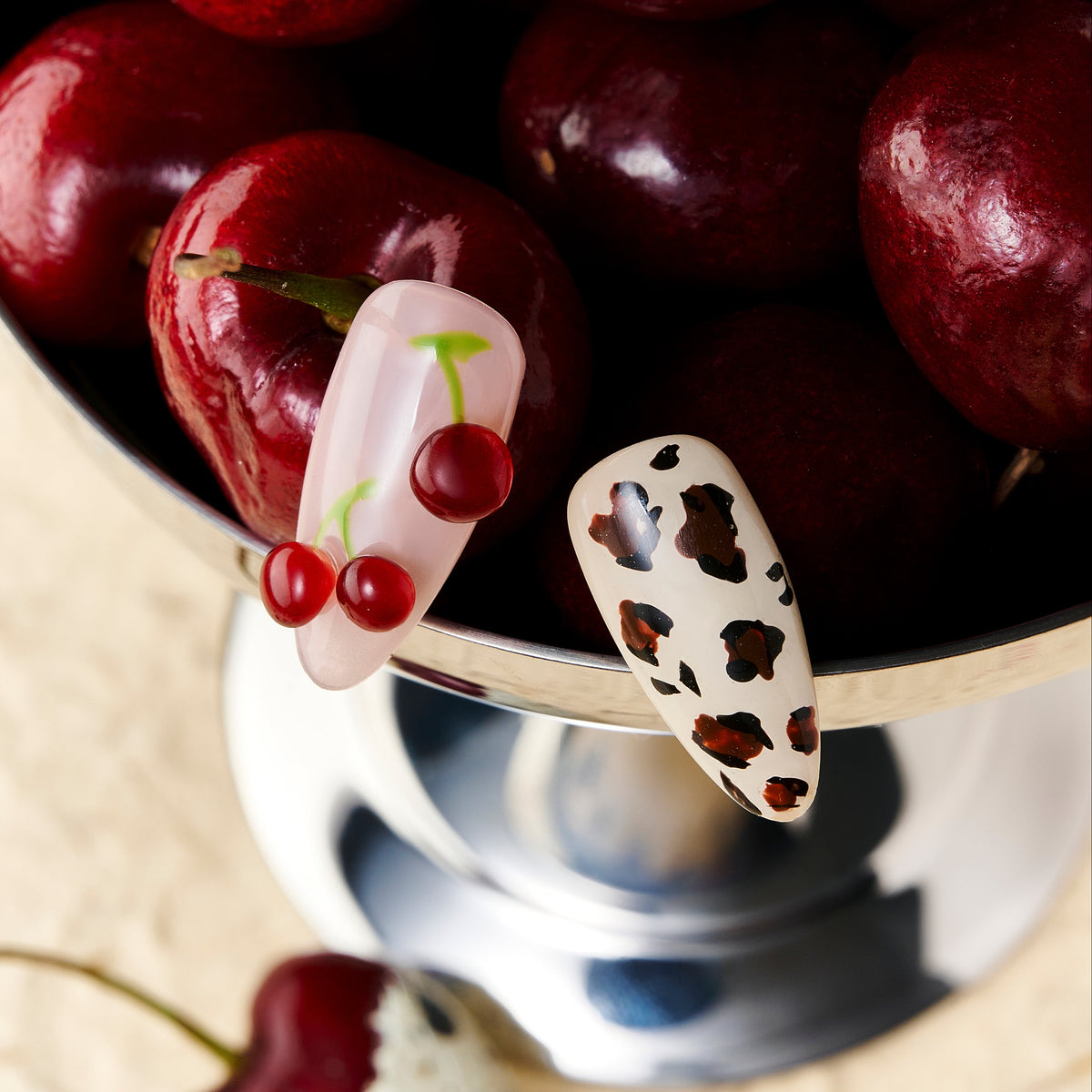 Almond press on nails with cherry art and brown leopard print on nude and pink base