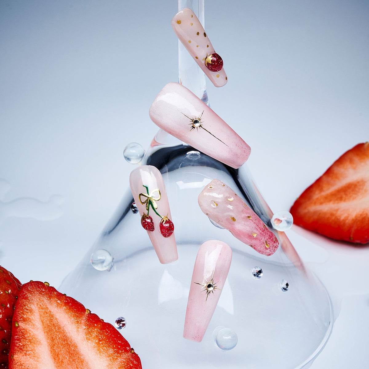 Cherry glow press on nails featuring glossy fruit accents. Elegant almond shape and reusable comfort fit.