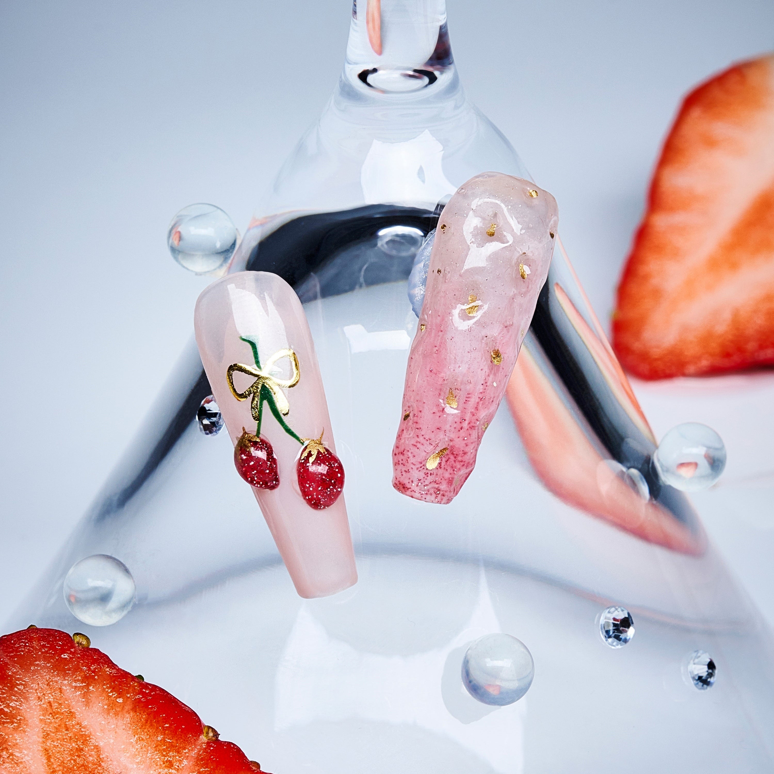 Cherry glow press on nails featuring glossy fruit accents. Elegant almond shape and reusable comfort fit.