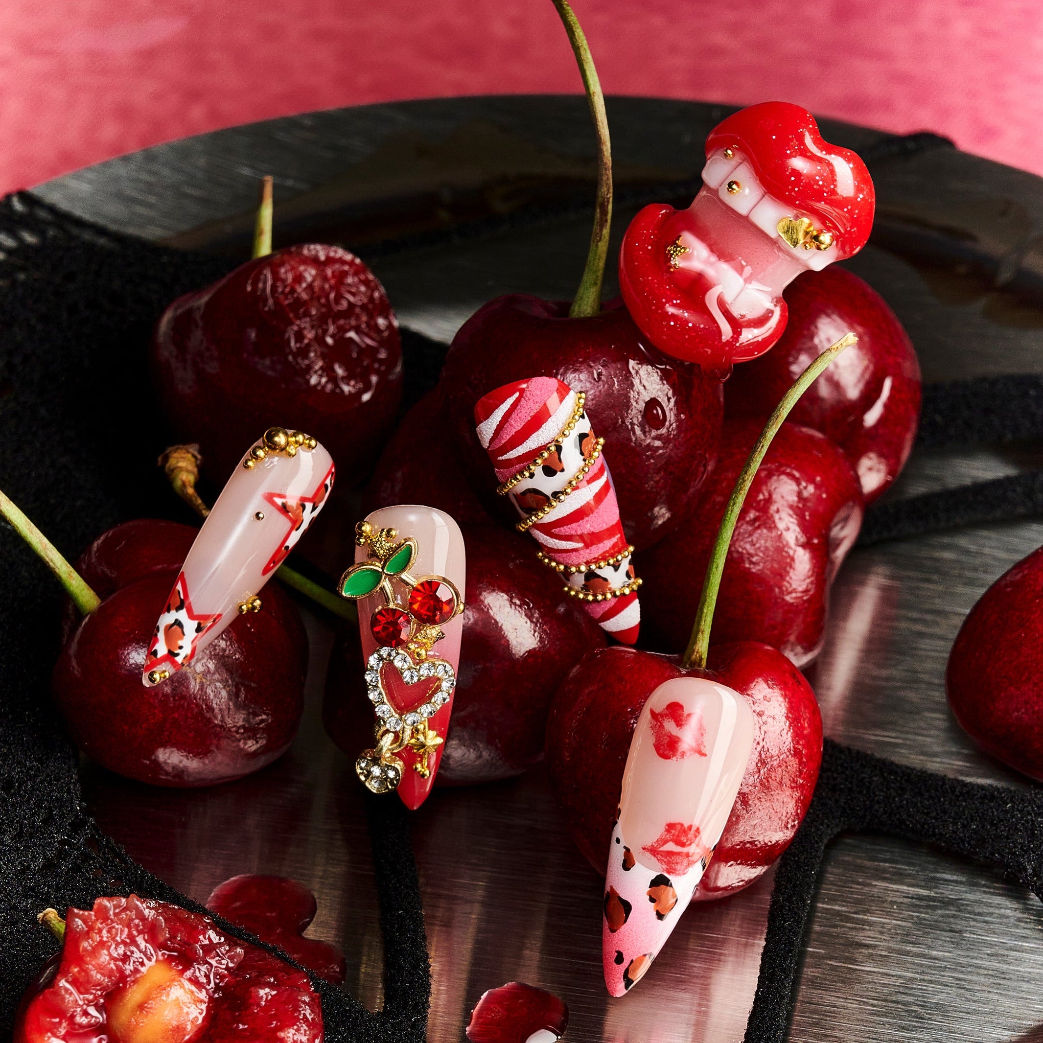 Press on nails with 3D red lips, cherry charm, leopard print, and pink-red mixed designs