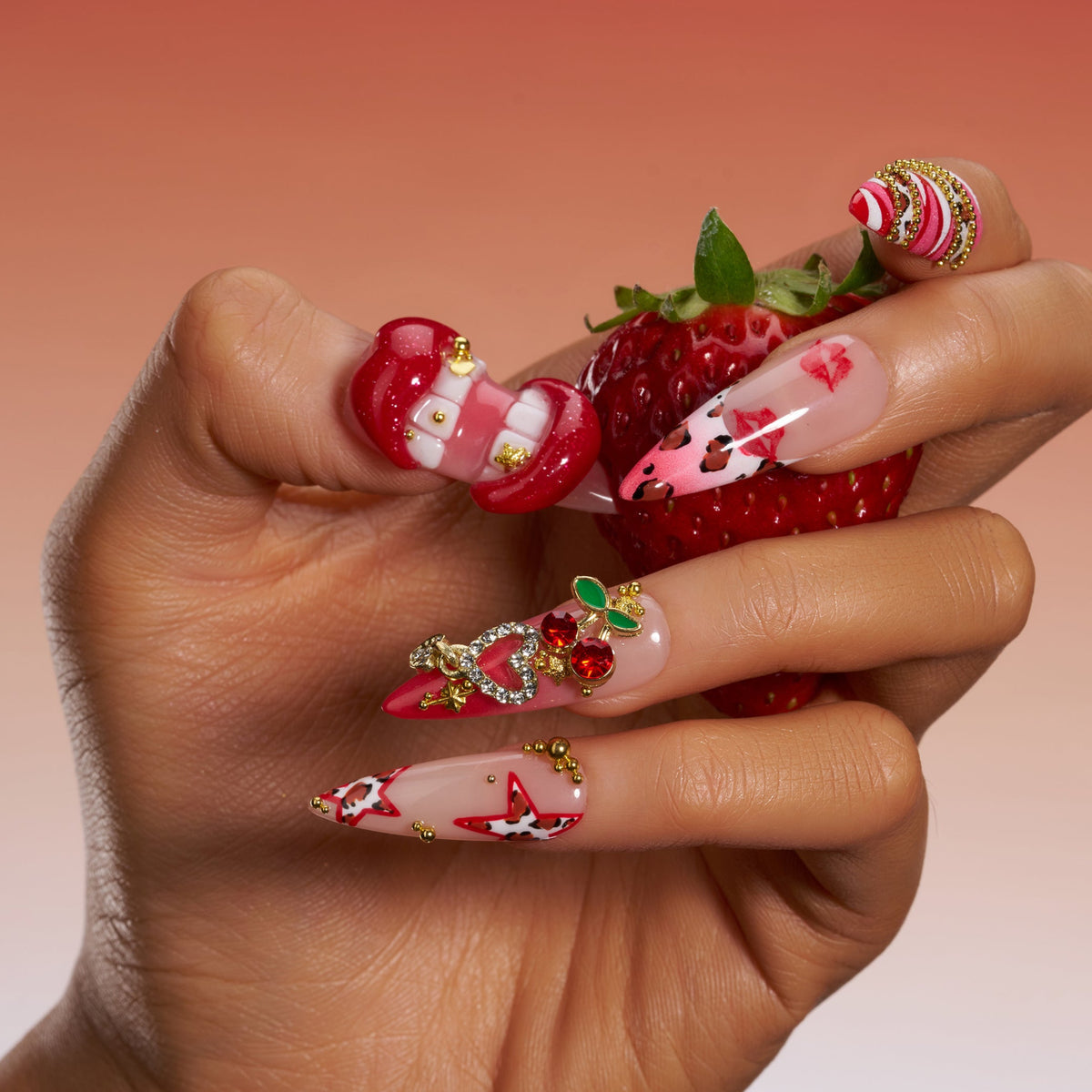 Press on nails with 3D red lips, cherry charm, leopard print, and pink-red mixed designs