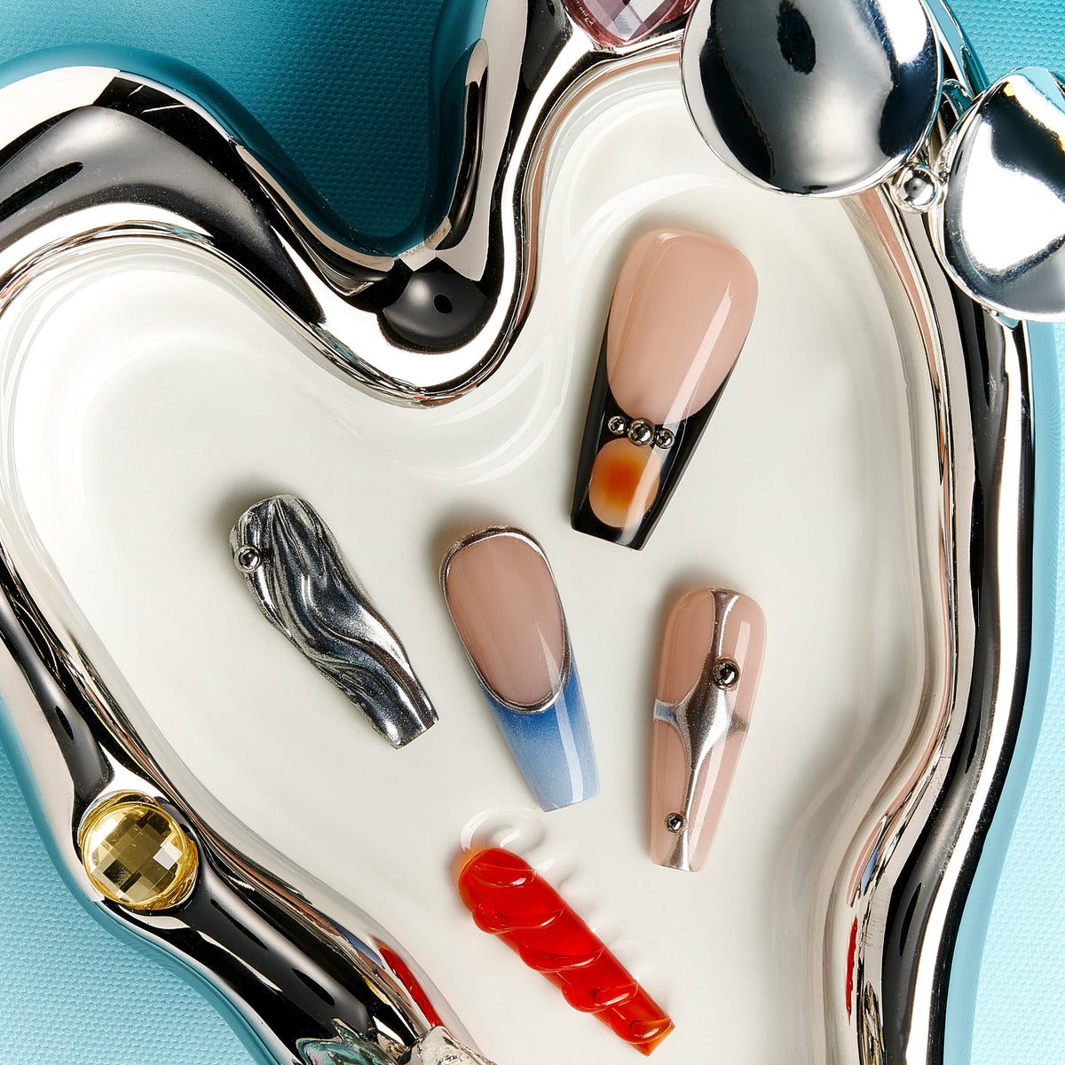 Cold toned coffin press on nails featuring silver chrome waves and blue gradient accents. Futuristic, glossy and reusable.