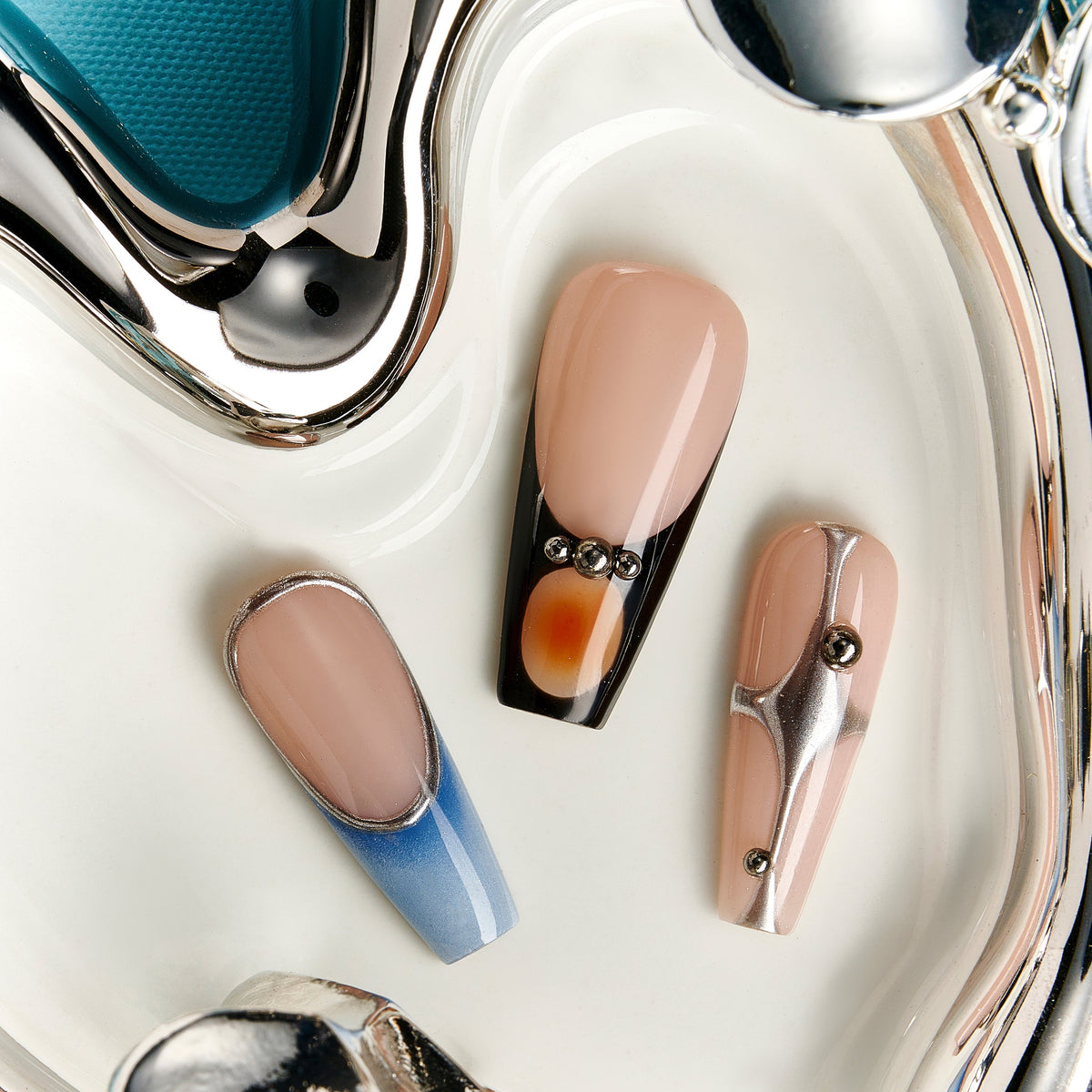 Cold toned coffin press on nails featuring silver chrome waves and blue gradient accents. Futuristic, glossy and reusable.