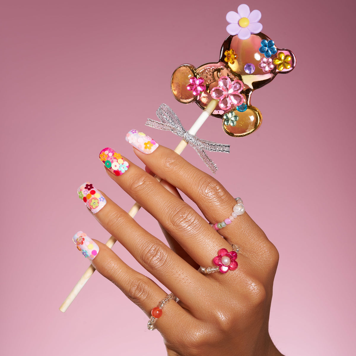 Colorful floral press on nails featuring 3D flower embellishments. Bold, fun and reusable nail set.