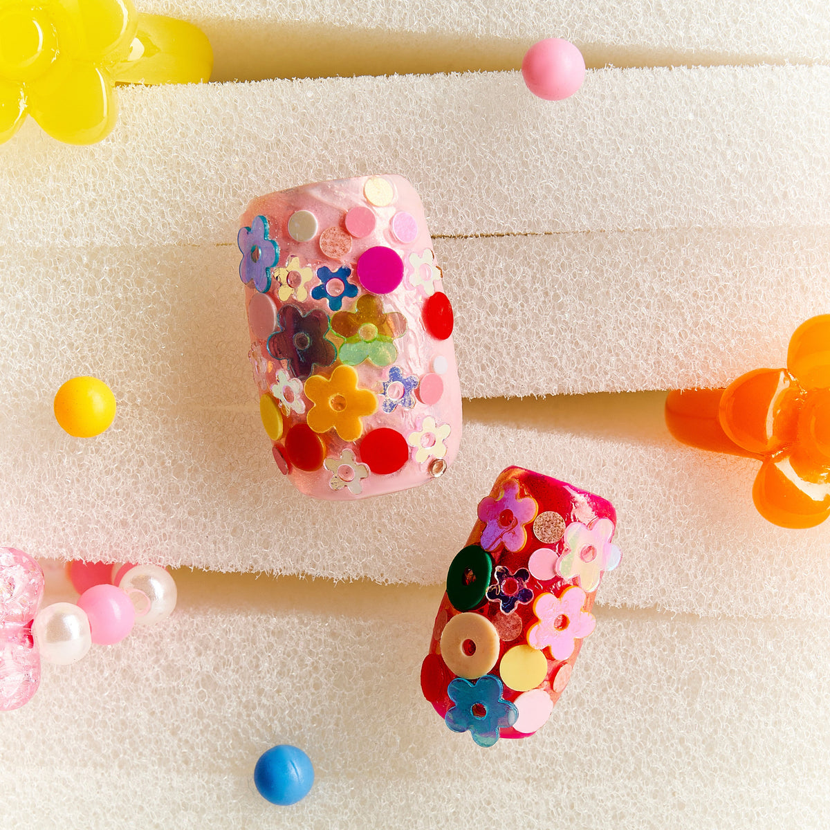 Colorful floral press on nails featuring 3D flower embellishments. Bold, fun and reusable nail set.
