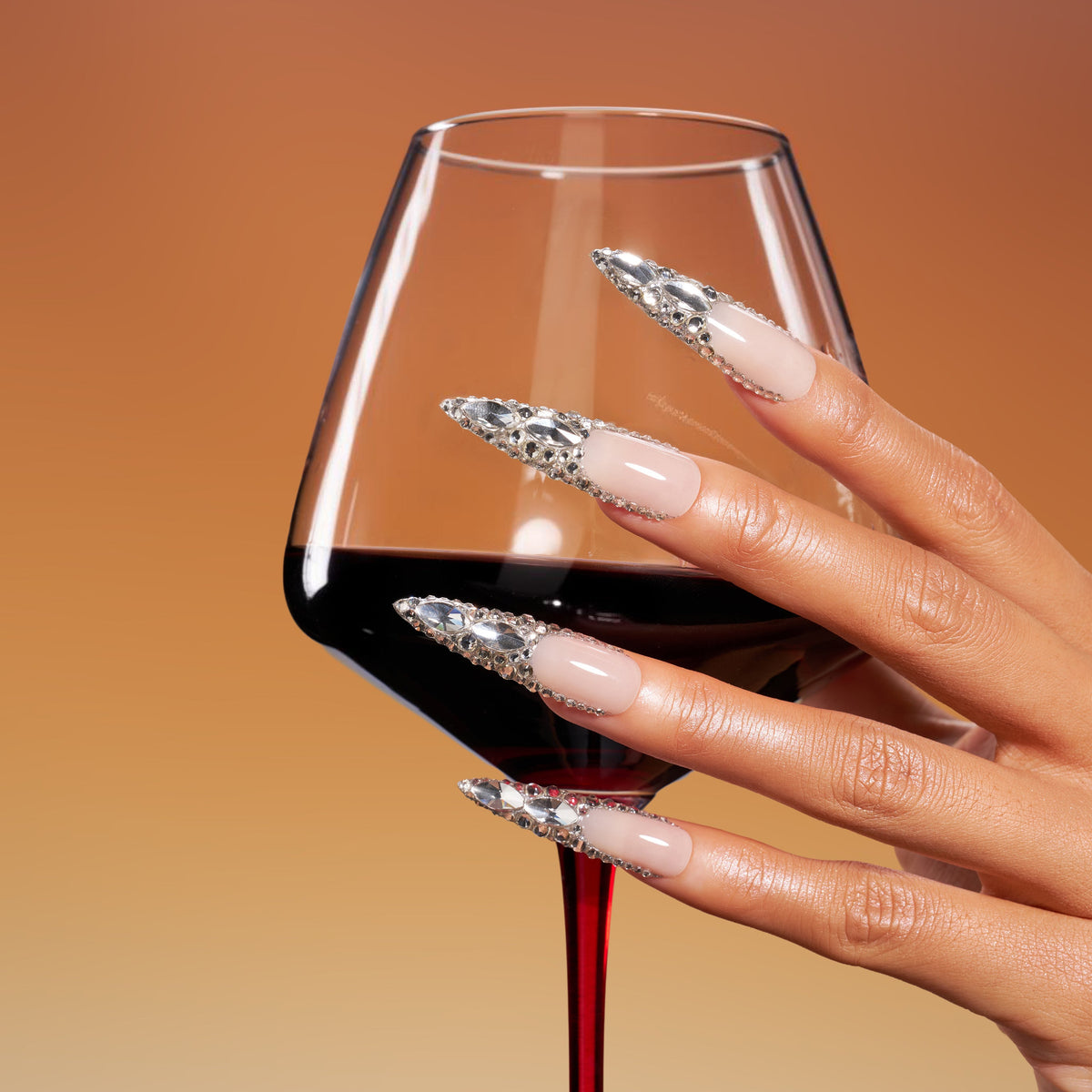 Crystal Wings luxury press on nails featuring premium Swarovski® crystals. Handmade reusable nail art set with dramatic shine and elegant nude base.
