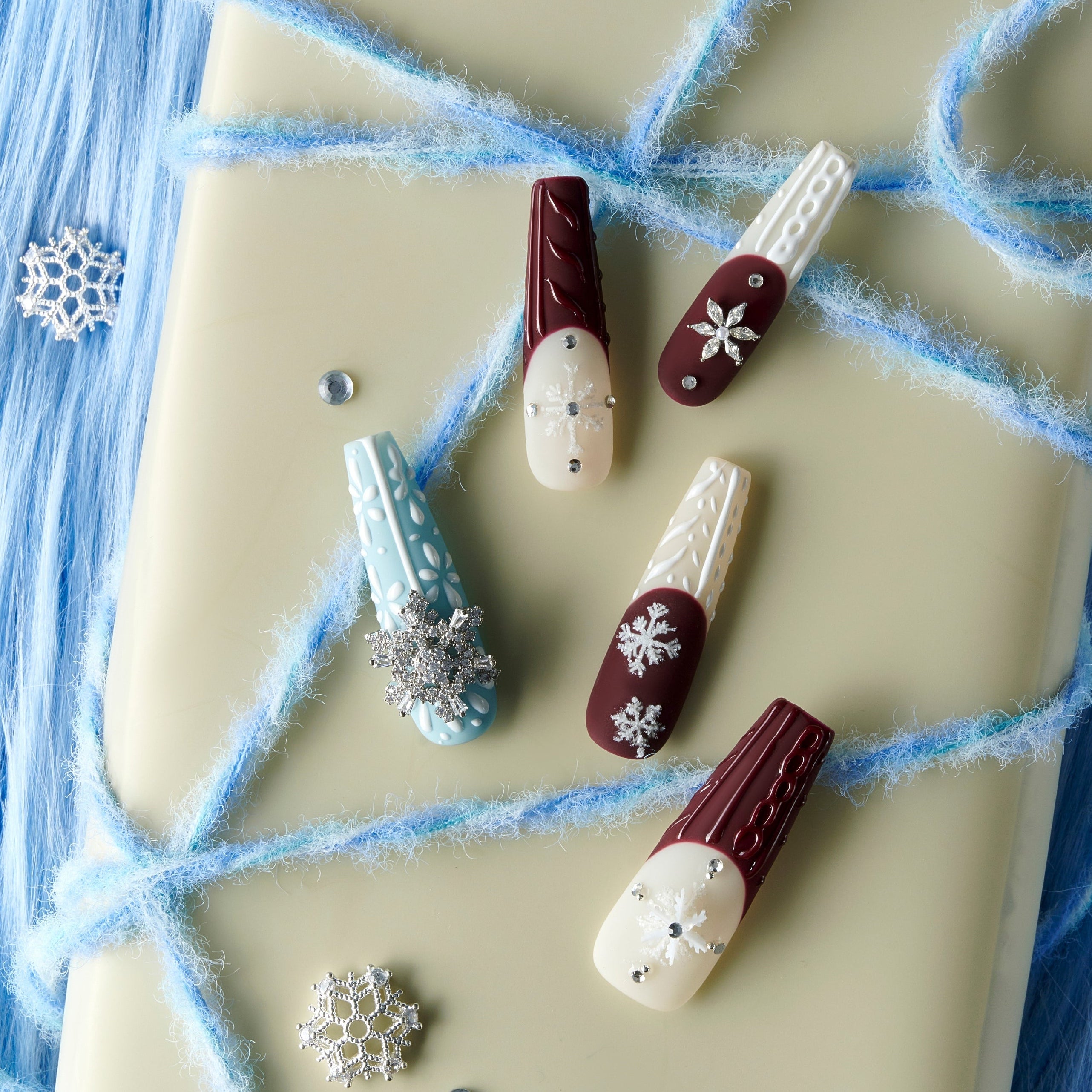 Dance of the Cosmos Christmas press on nails with 3D knit texture, snowflake charms, red and blue winter design long nail