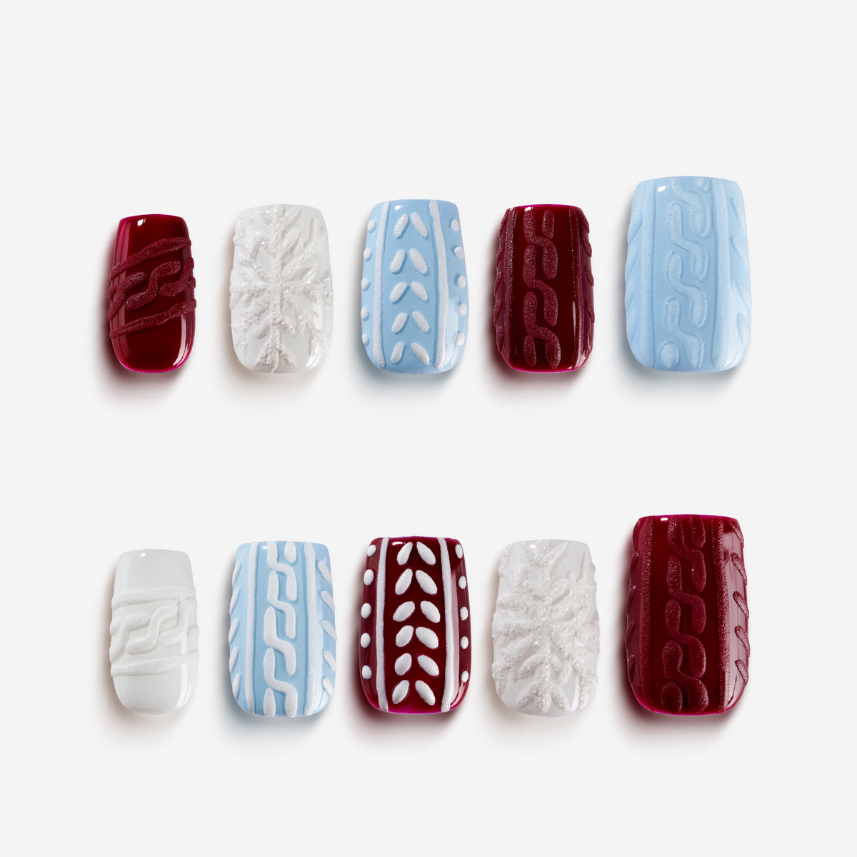 Dream Weave Crimson Christmas nails with red, white, and blue knit sweater texture design for winter holiday style