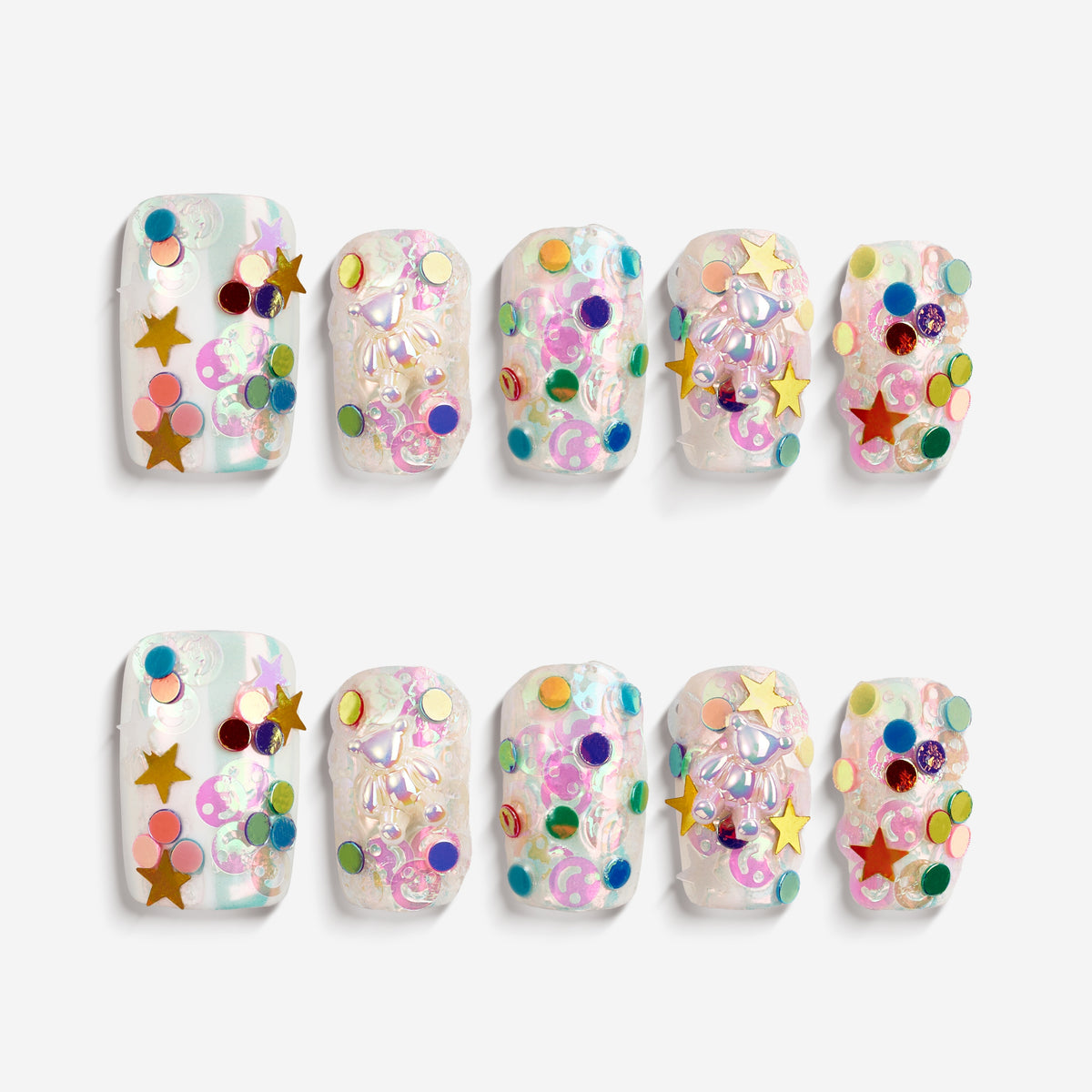 Colorful iridescent 3D press on nails with stars and glitter. Cute festival-ready statement set.