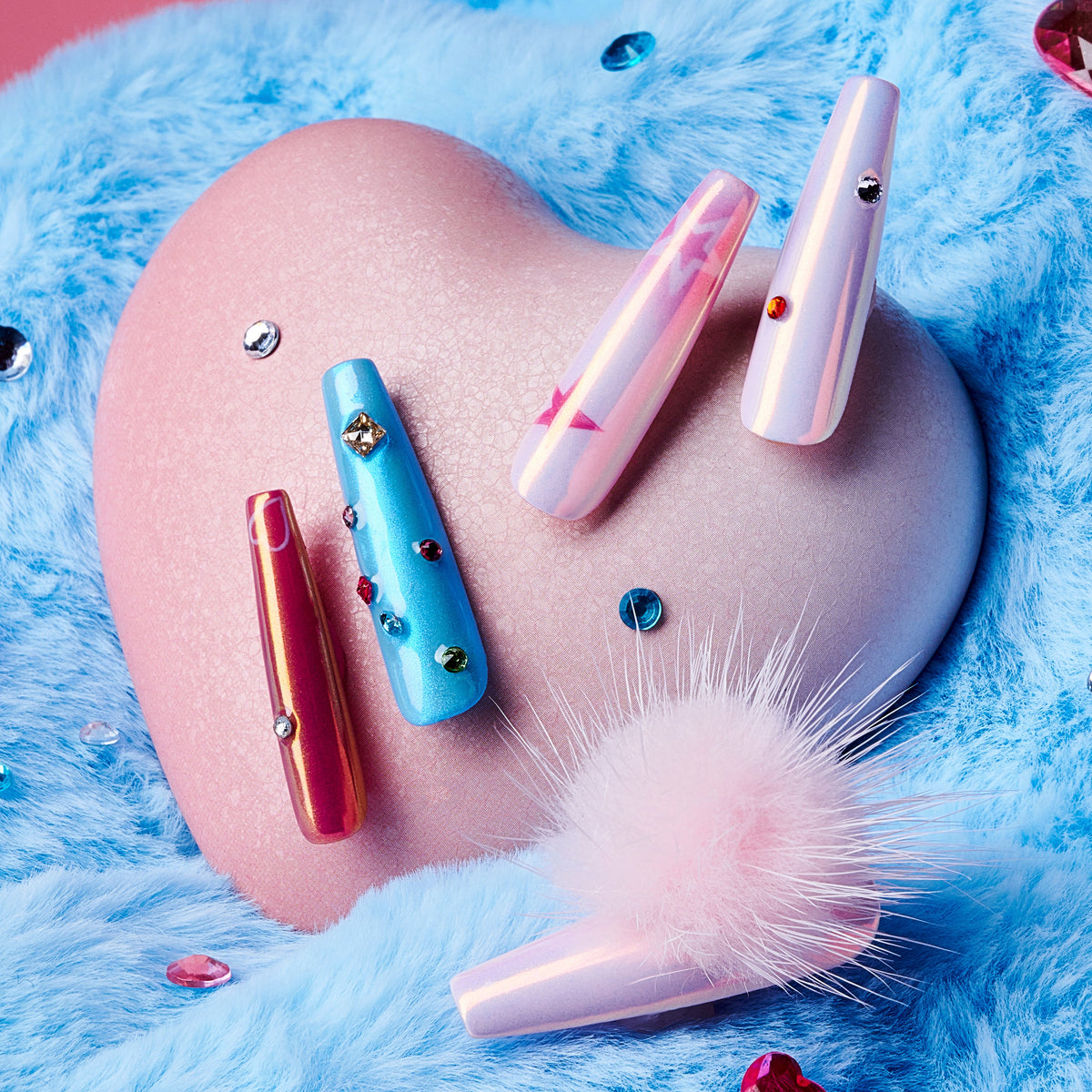 Barbie Stardream – Halloween press on nails with pink shimmer, candy-blue accents, rhinestones, and fluffy pom-poms