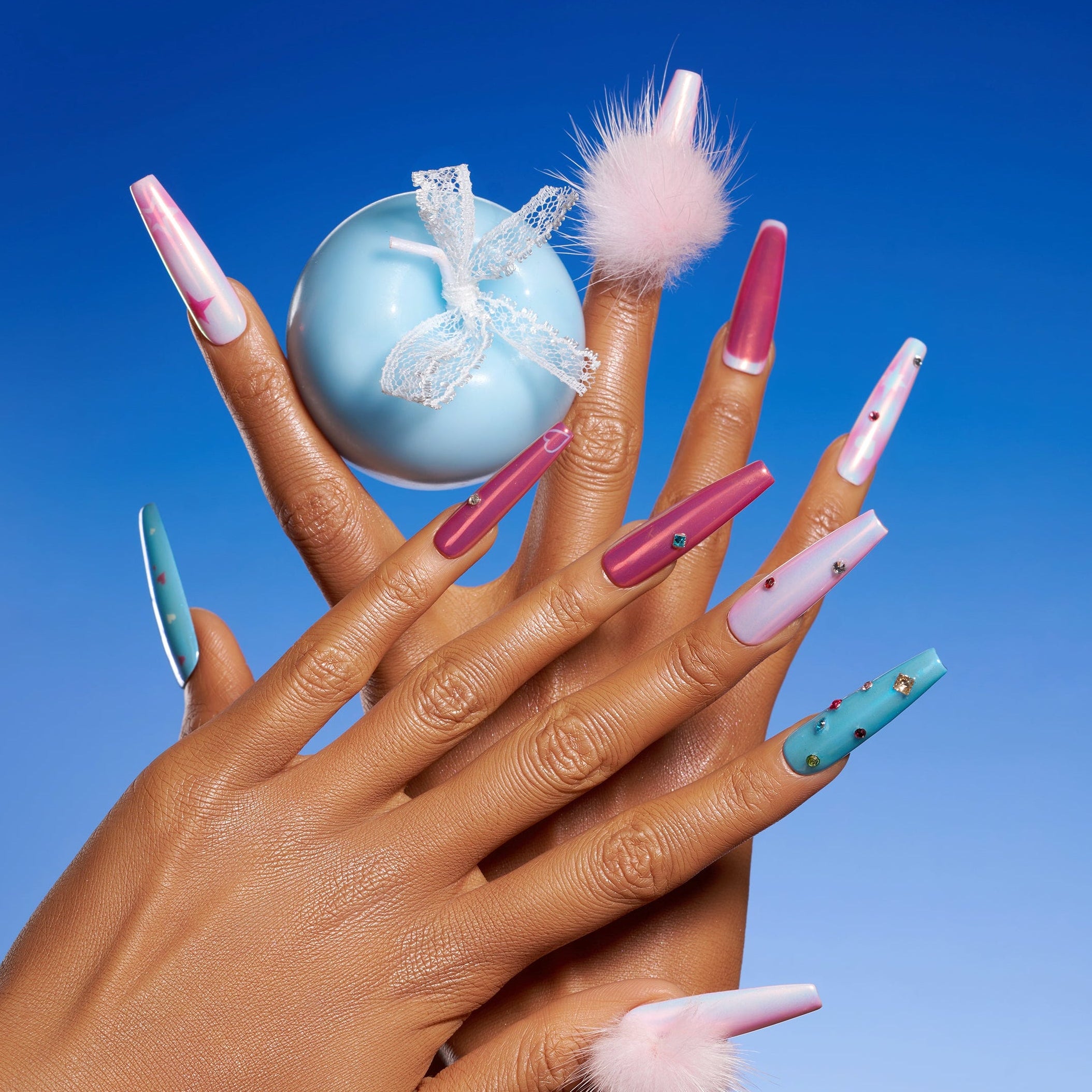 Barbie Stardream – Halloween press on nails with pink shimmer, candy-blue accents, rhinestones, and fluffy pom-poms