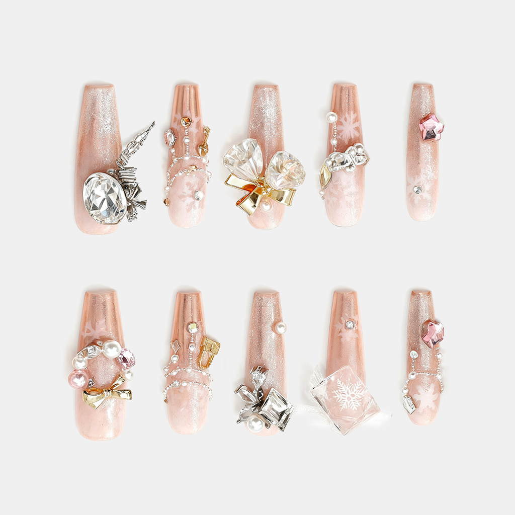 Champagne Snow Veil – pearl champagne Christmas nails with snowflake accents and crystal charm details