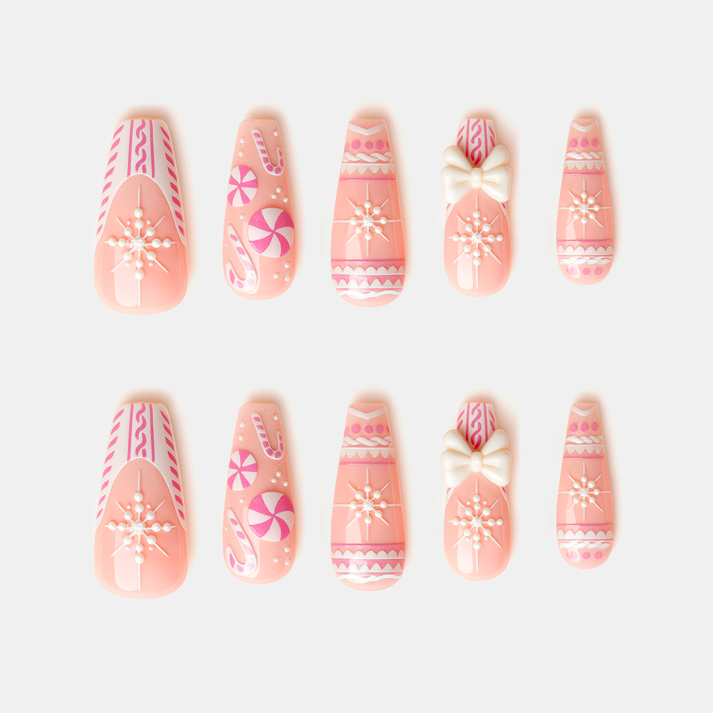 Sweet Snow Charm – pink Christmas press-on nails with snowflake, candy, and bow decorations