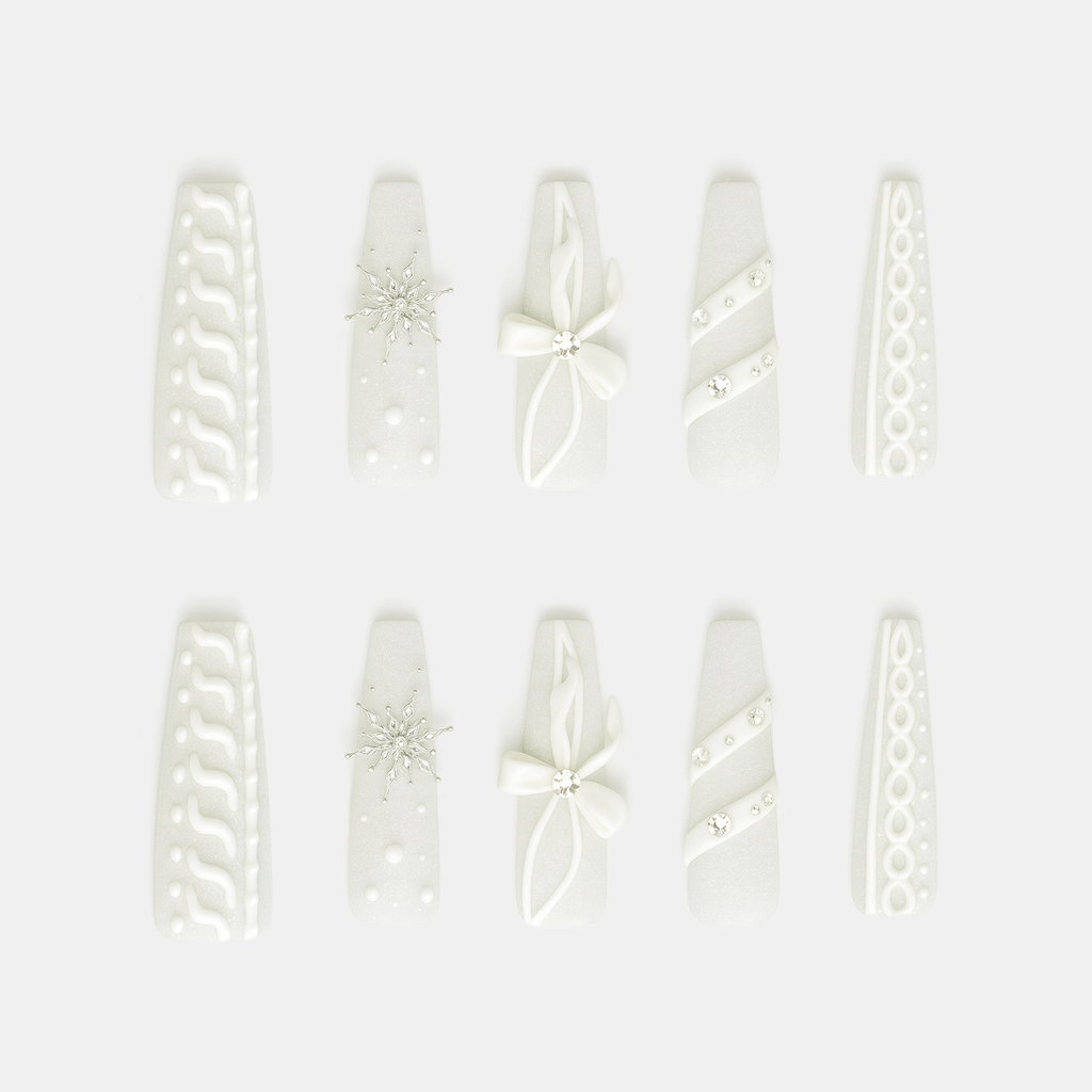 Winter Snowflakes – white press-on nails with 3D snowflake carvings, ribbons, and pearl details for Christmas and winter