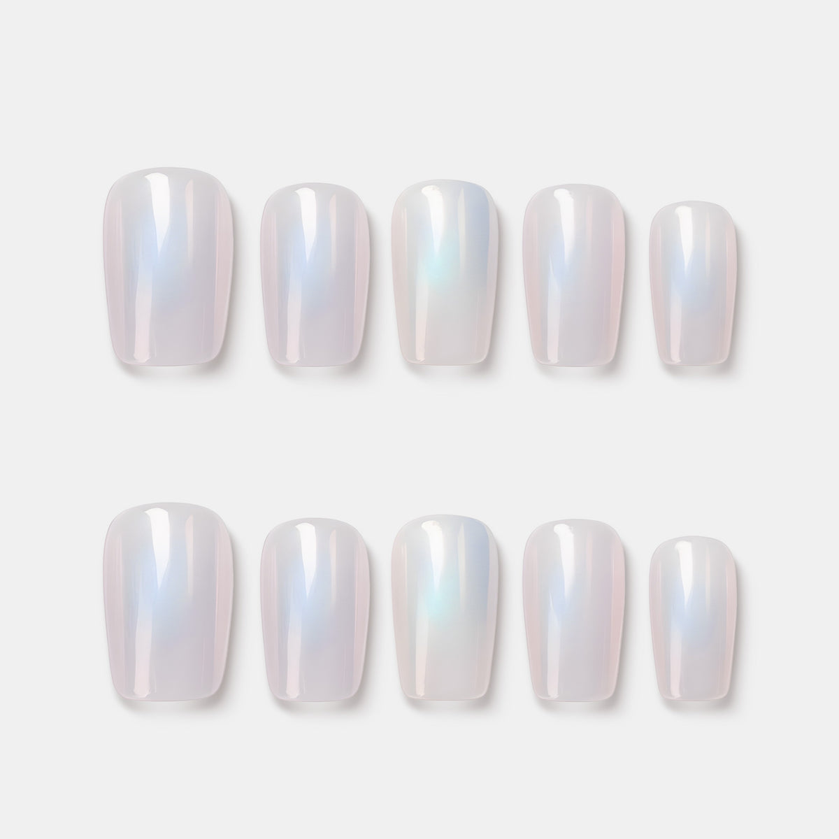 Moonbow Icing press on nails featuring milky white iridescent glow. Trendy luminous false nails.