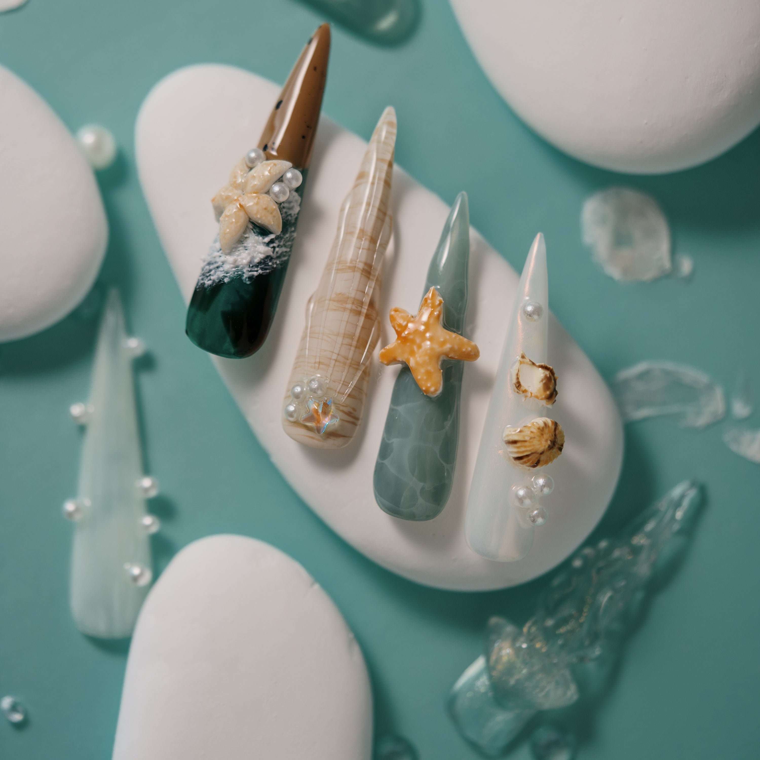 Dresup Ocean Mystique press on nails with green gradient and 3D sea elements. Statement stiletto false nails.