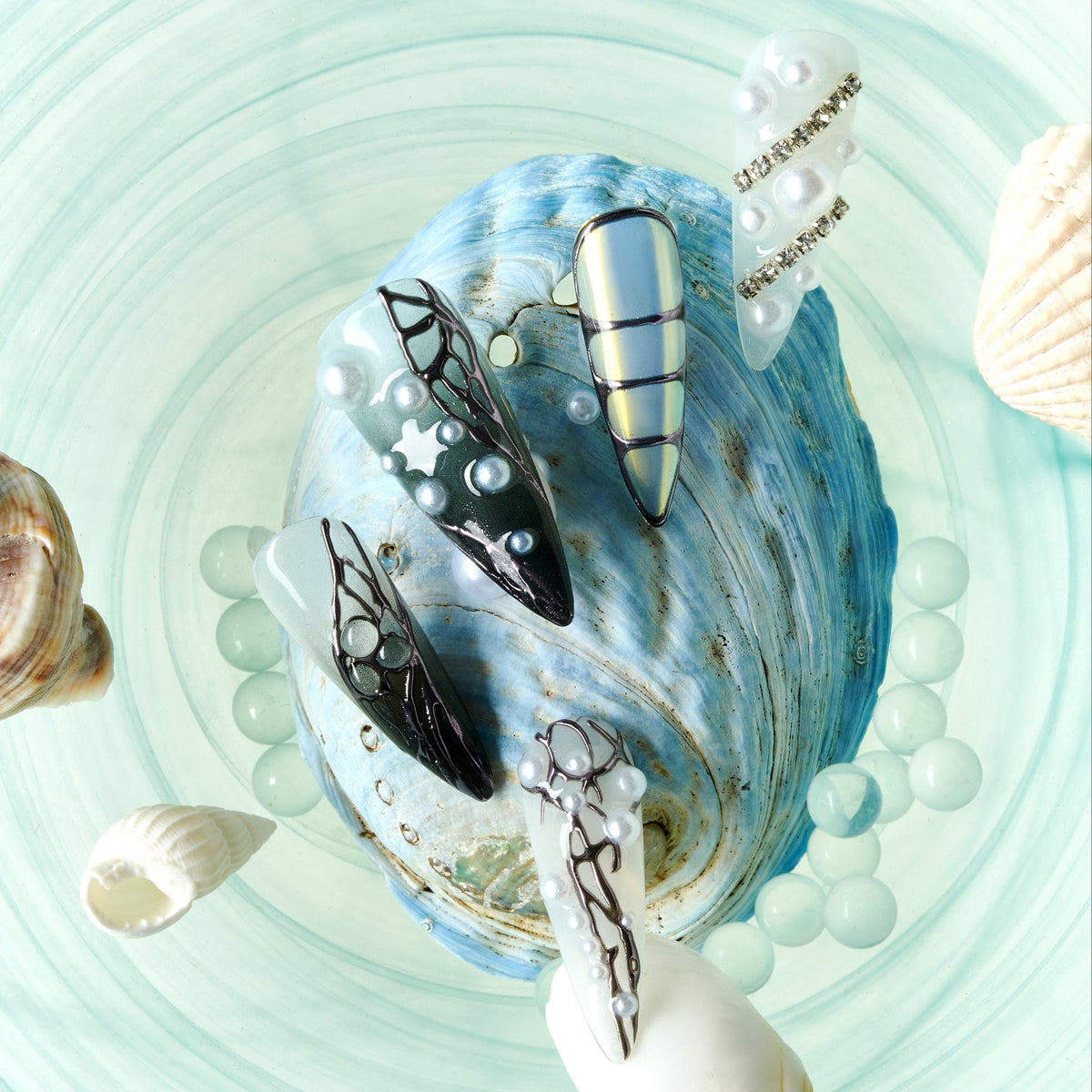 dresup Silver Coral press on nails featuring chrome texture and pearl details. Luxury ocean-inspired false nails.