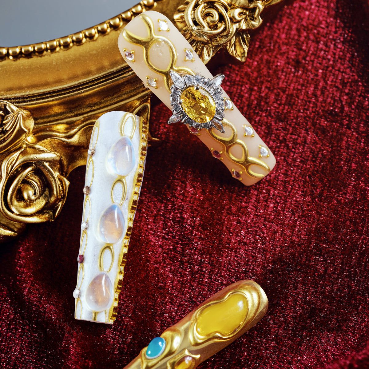 Luxury gold and turquoise gemstone press on nails with sculpted metal texture and jewel accents