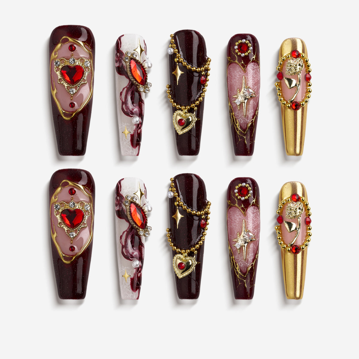 Burgundy press on nails with gold detailing and heart gemstone accents. Romantic, bold and reusable.