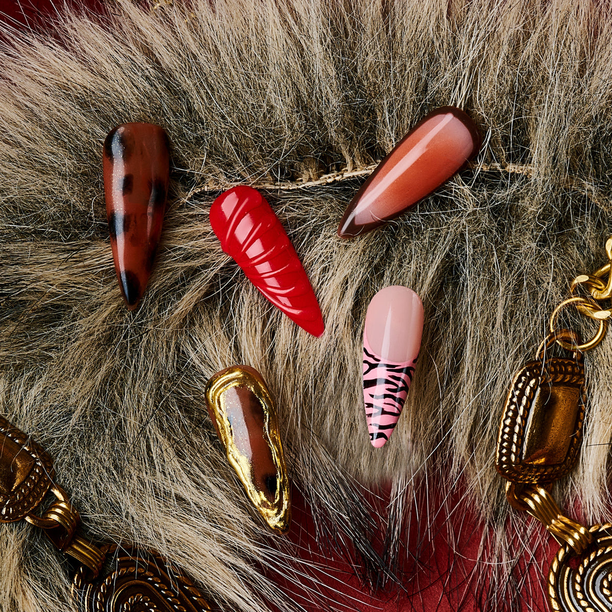 Fiery Flow press on nails with red marble, animal print, and gold-frame accents