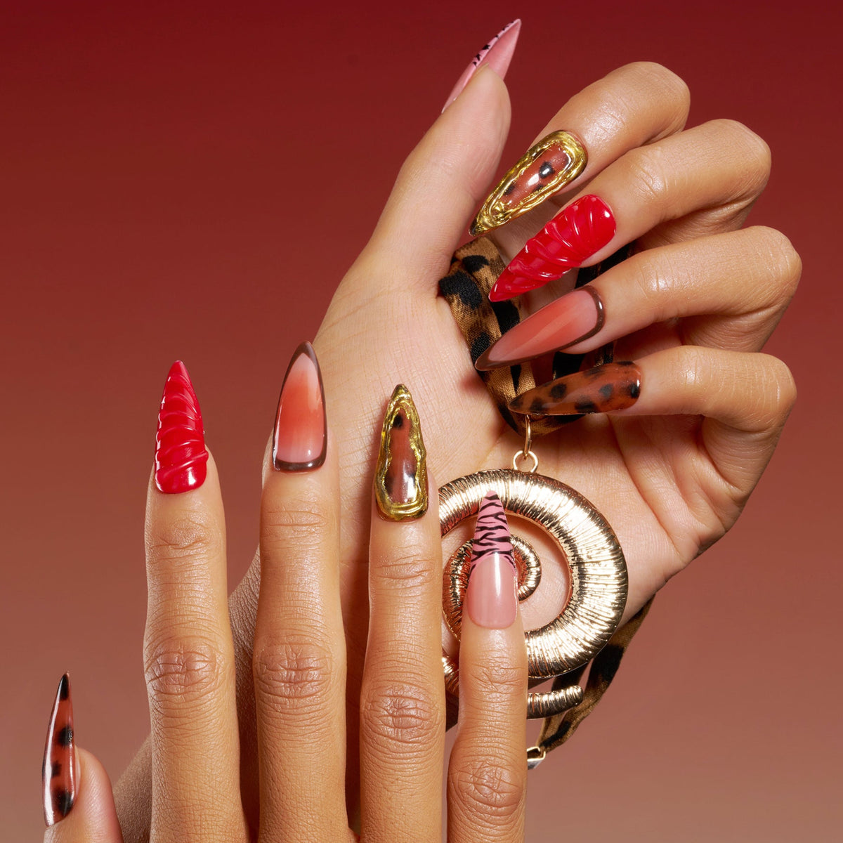 Fiery Flow press on nails with red marble, animal print, and gold-frame accents