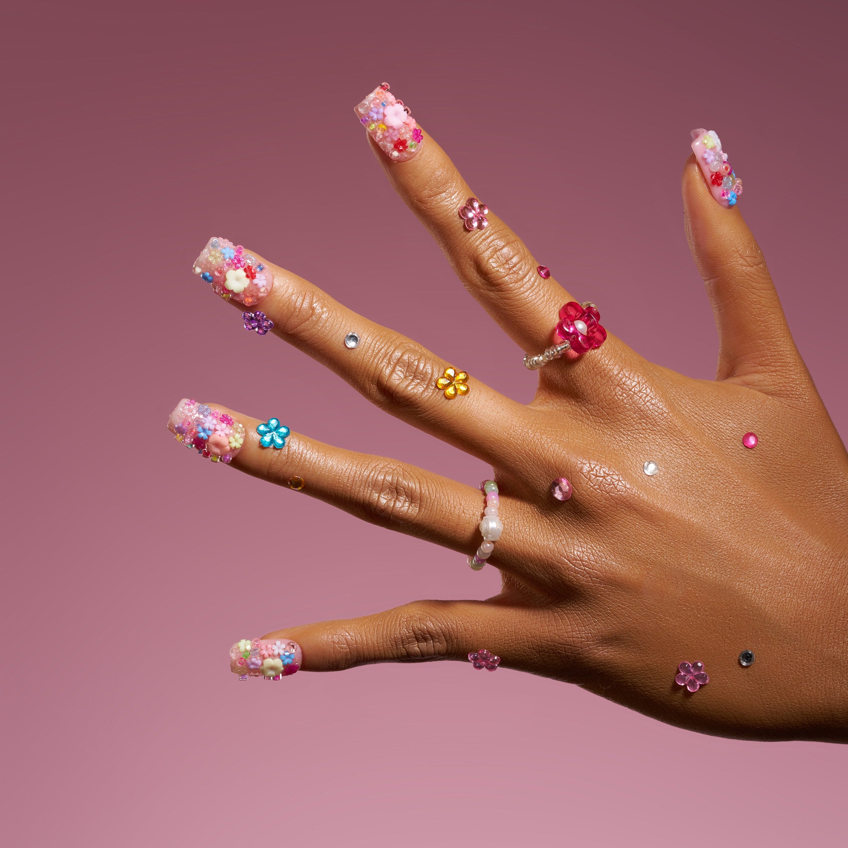 Romantic 3D floral press on nails with pastel embellishments. Soft glam and reusable design.