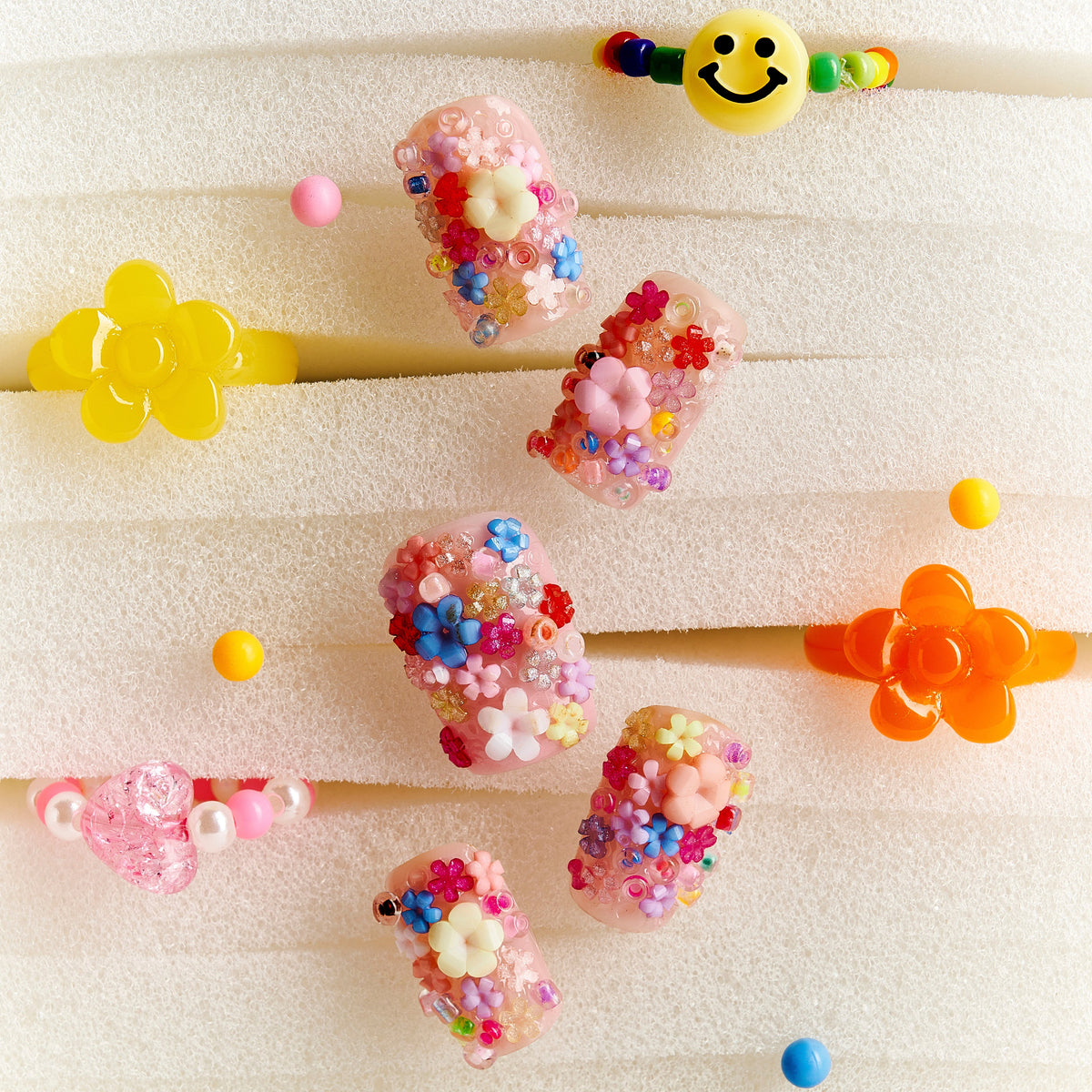 Romantic 3D floral press on nails with pastel embellishments. Soft glam and reusable design.