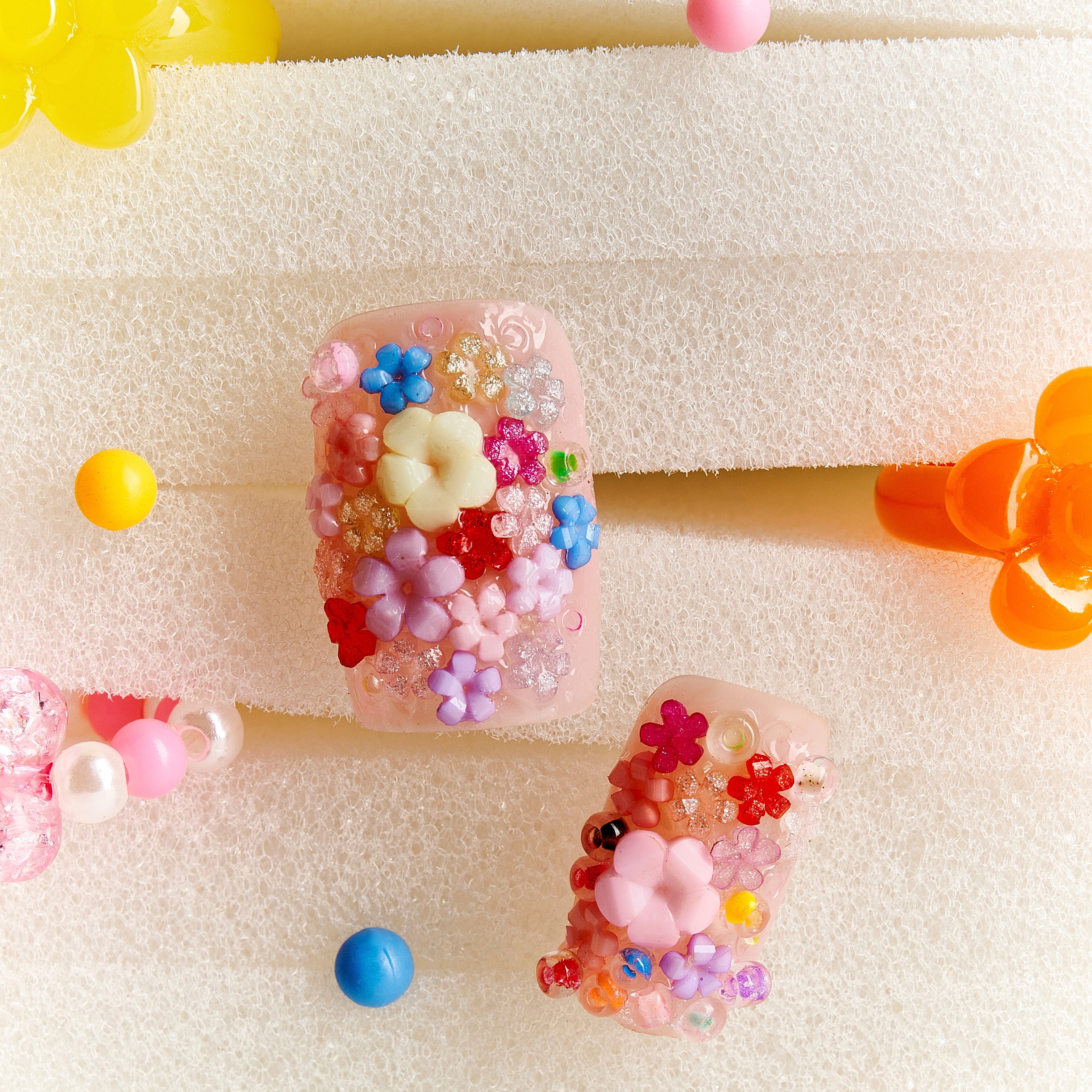 Romantic 3D floral press on nails with pastel embellishments. Soft glam and reusable design.