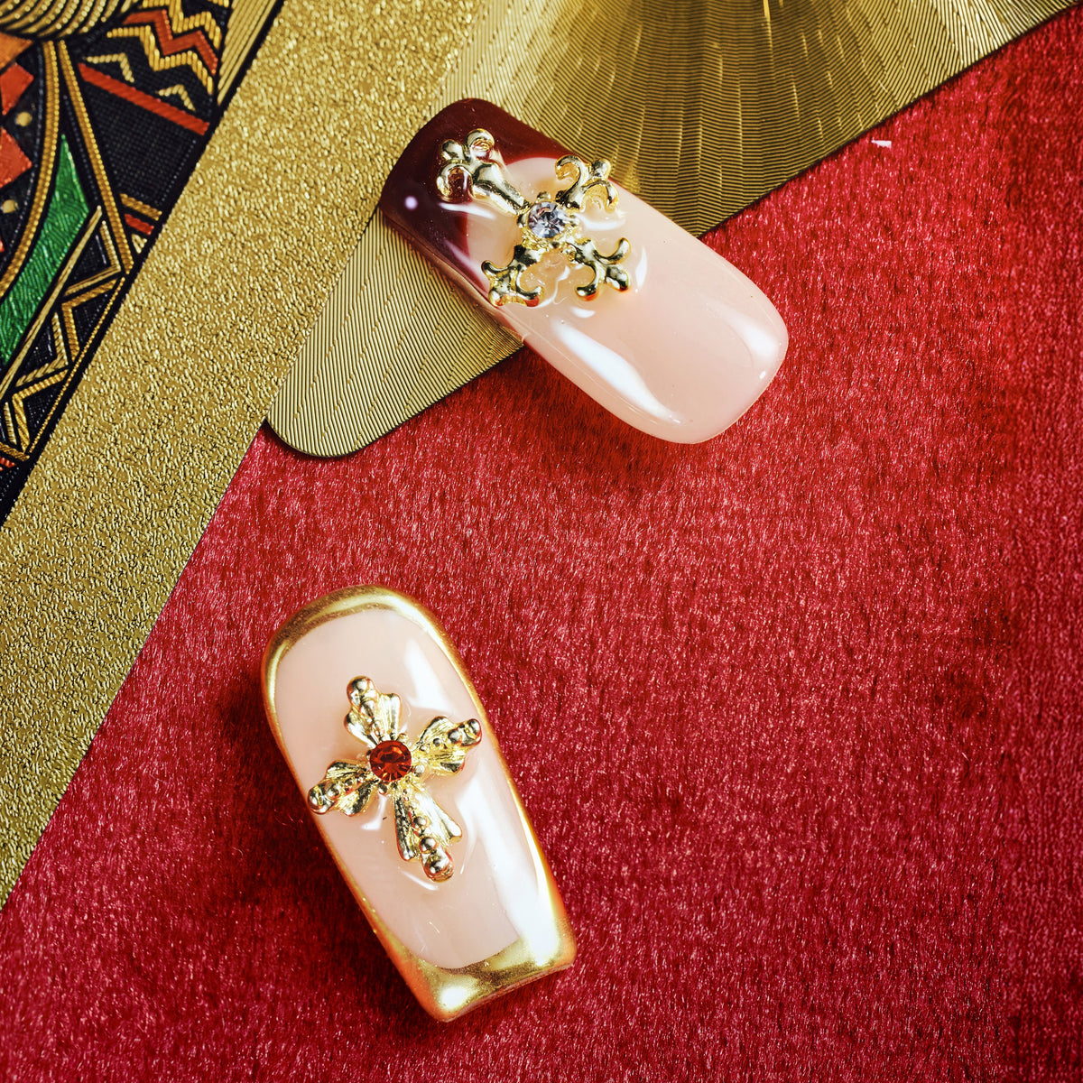 Elegant nude press on nails with gold foil and cross embellishments. Reusable luxury nail set.