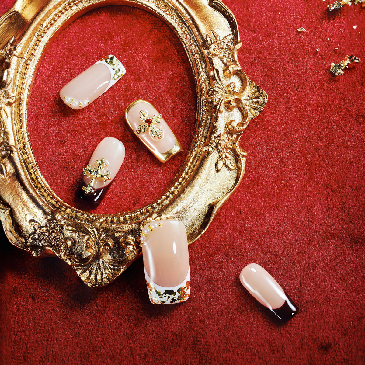 Elegant nude press on nails with gold foil and cross embellishments. Reusable luxury nail set.