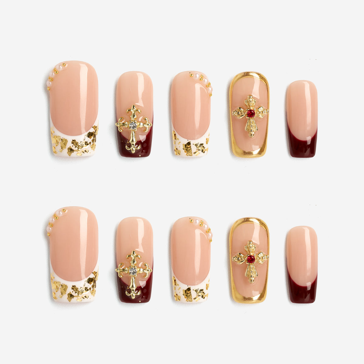 Elegant nude press on nails with gold foil and cross embellishments. Reusable luxury nail set.