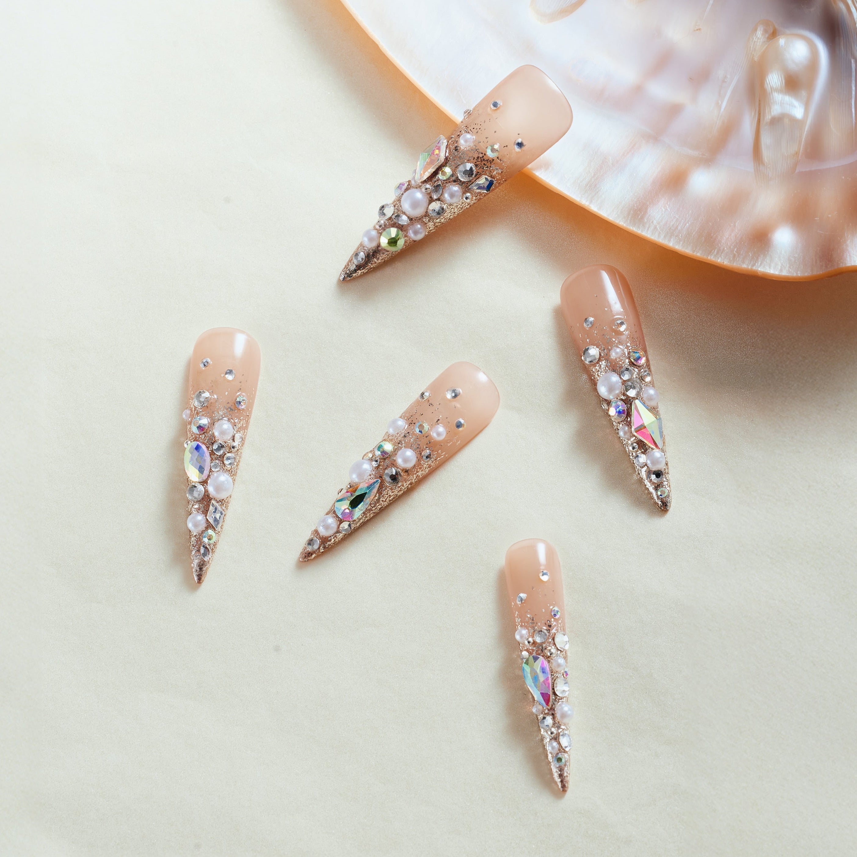Glittery Cosmos press on nails in rose gold glitter with 3D crystals and gemstone clusters