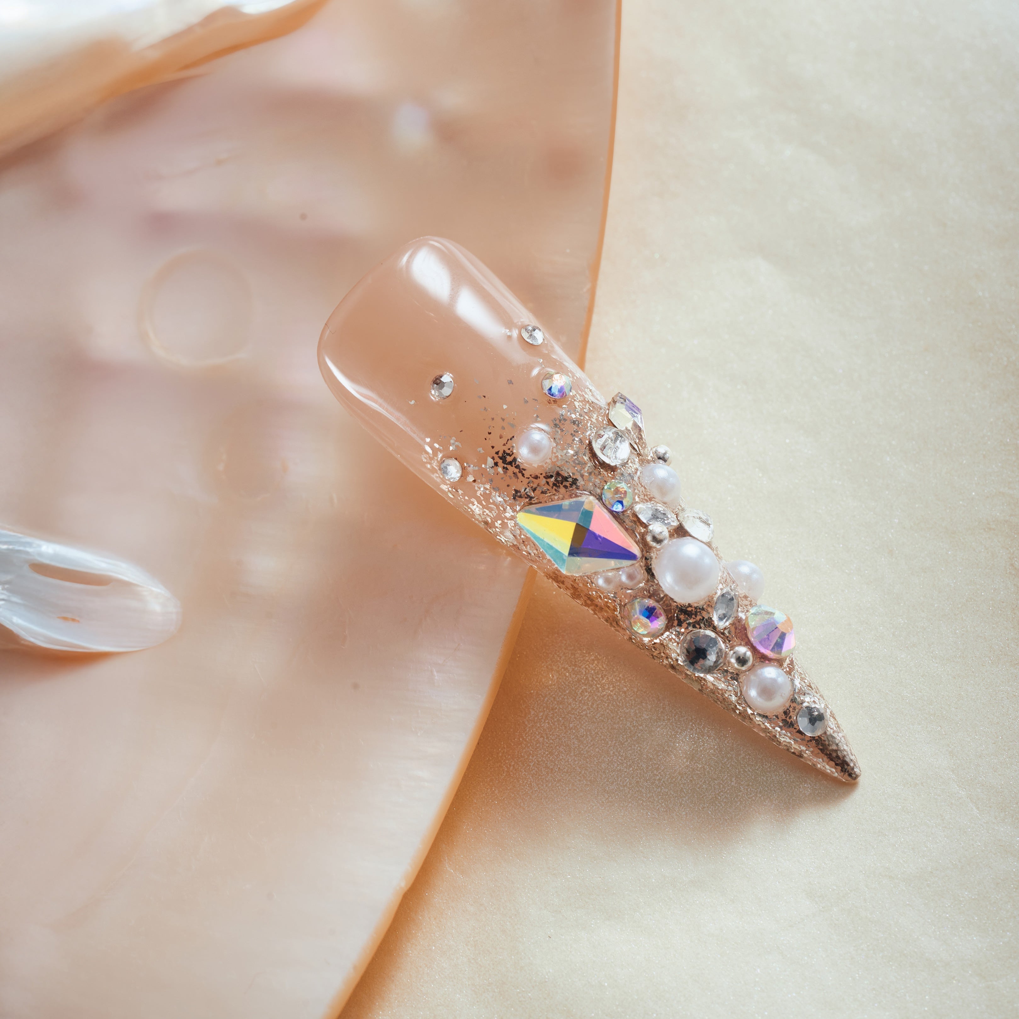 Glittery Cosmos press on nails in rose gold glitter with 3D crystals and gemstone clusters