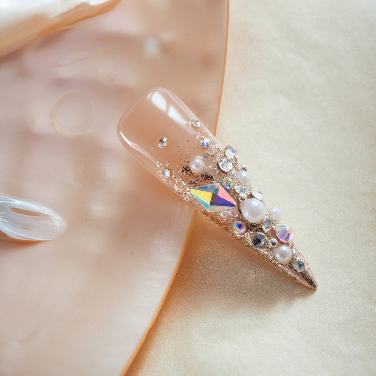 Glittery Cosmos press on nails in rose gold glitter with 3D crystals and gemstone clusters