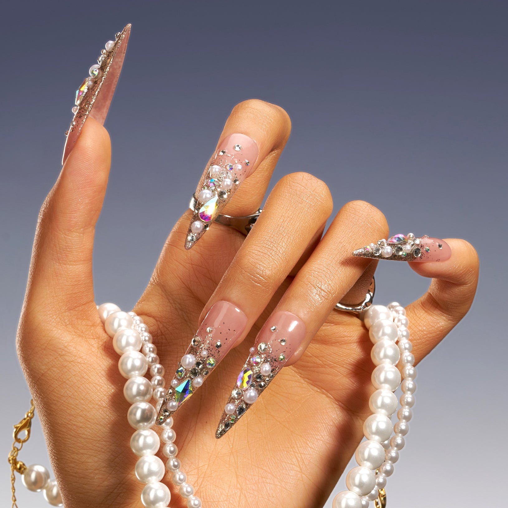 Glittery Cosmos press on nails in rose gold glitter with 3D crystals and gemstone clusters