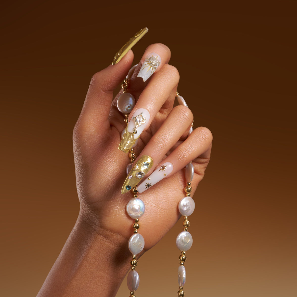 Luxury gold chrome press on nails with crystal details. High shine, sculpted texture and reusable glam design.