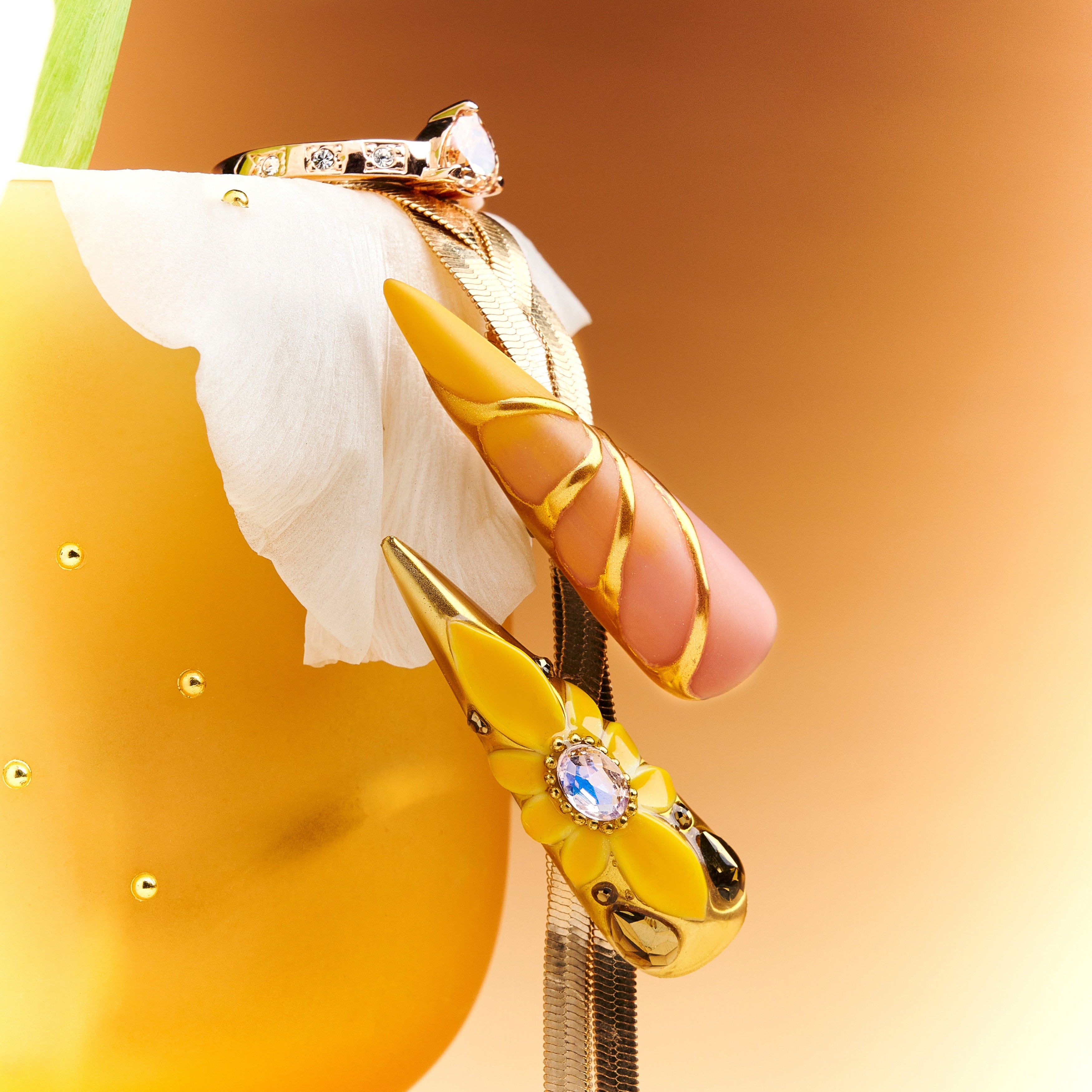 Luxury gold butterfly press on nails with gemstone accents. Dramatic stiletto shape and reusable salon finish.