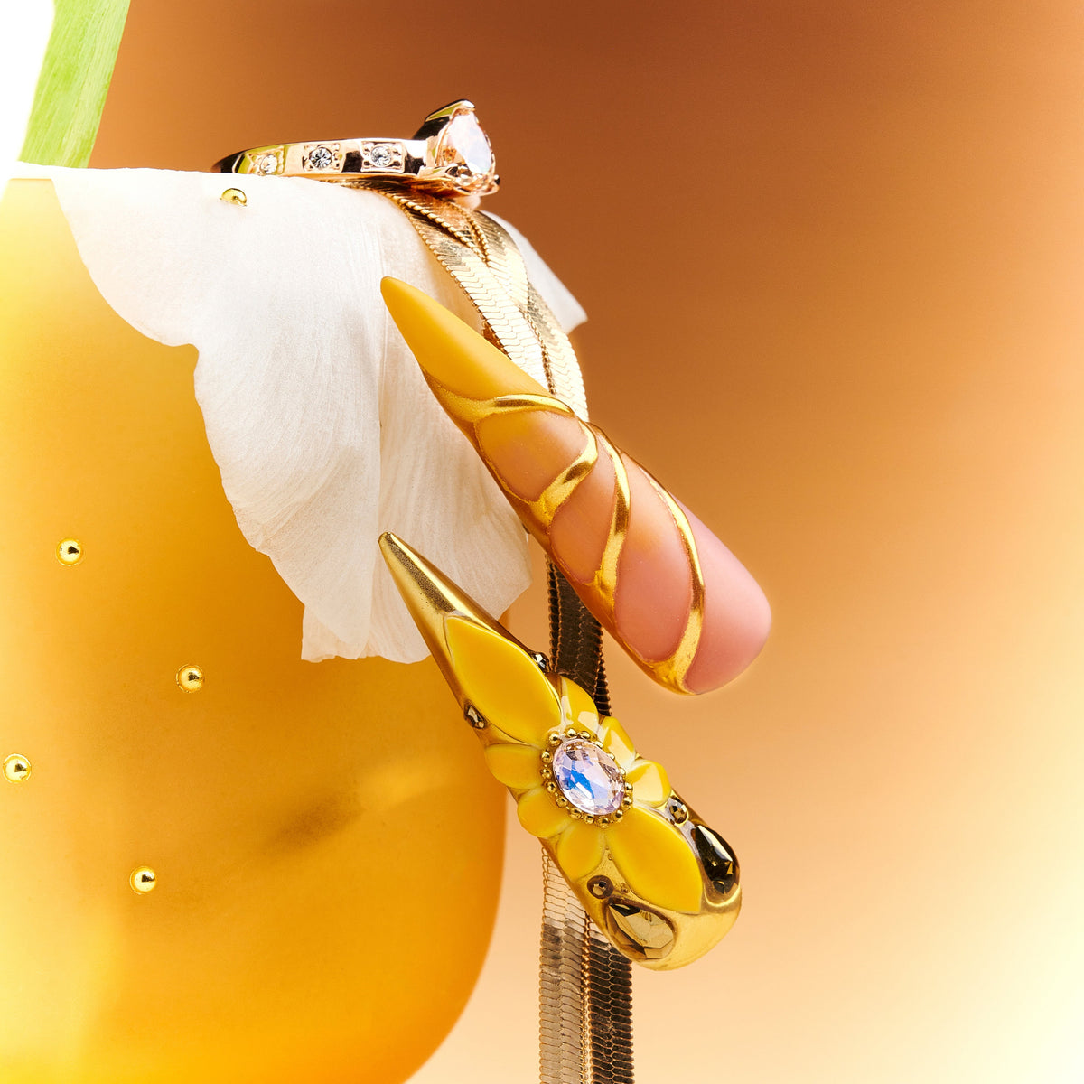 Luxury gold butterfly press on nails with gemstone accents. Dramatic stiletto shape and reusable salon finish.