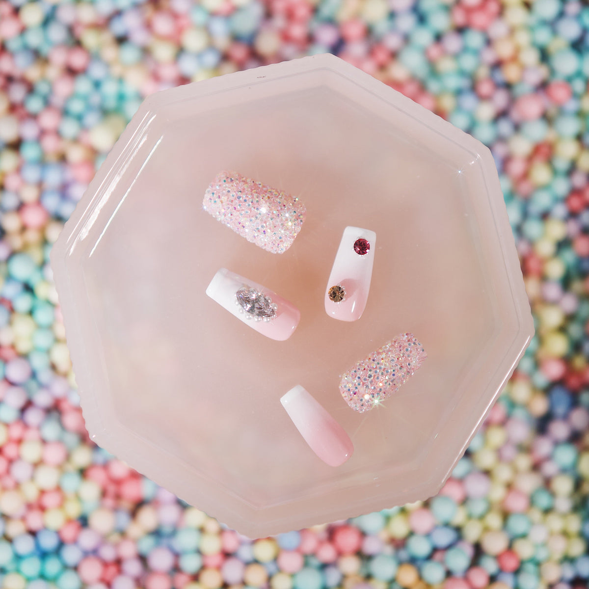 Elegant white pearl press on nails with gold detailing and shell textures. Refined and reusable.