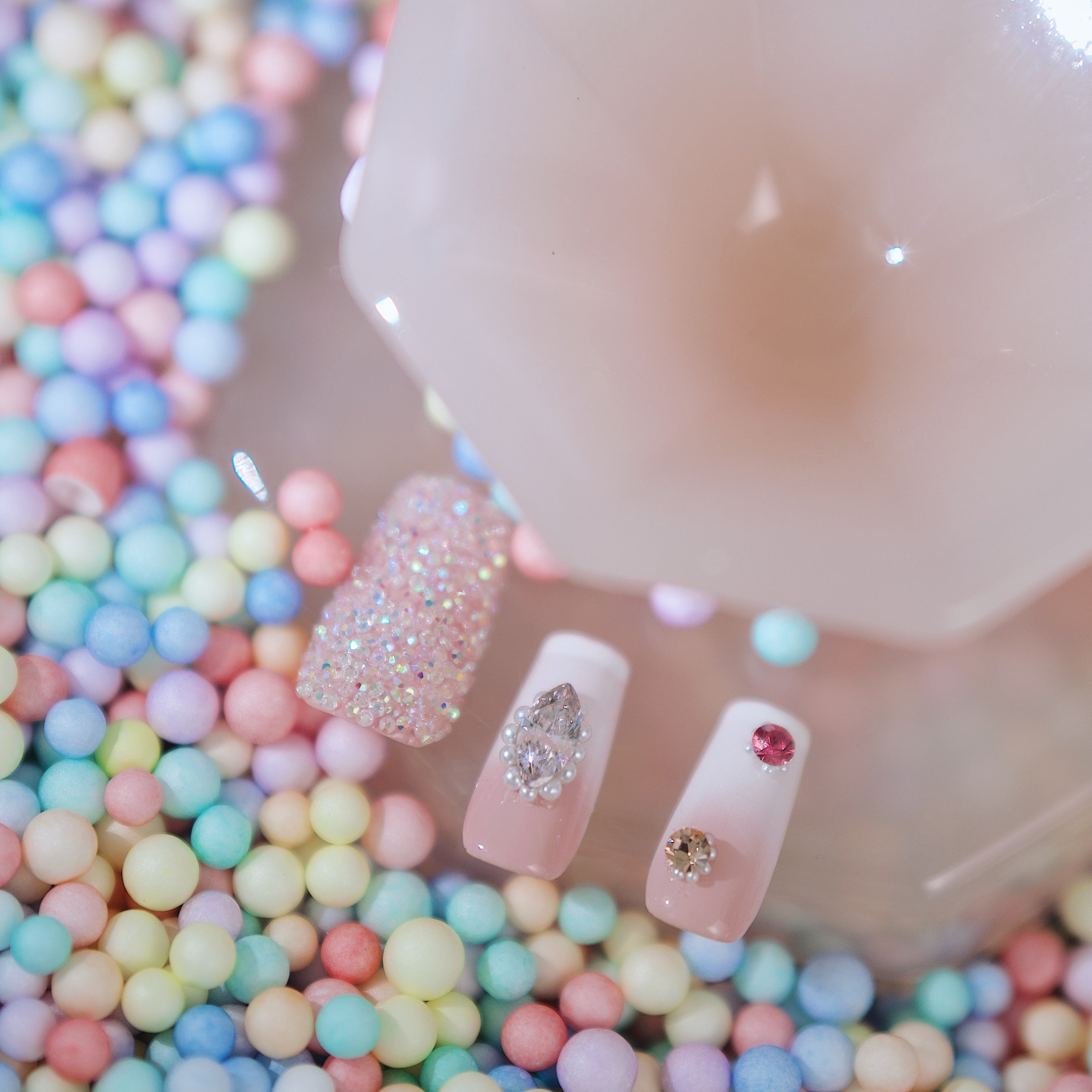 Elegant white pearl press on nails with gold detailing and shell textures. Refined and reusable.