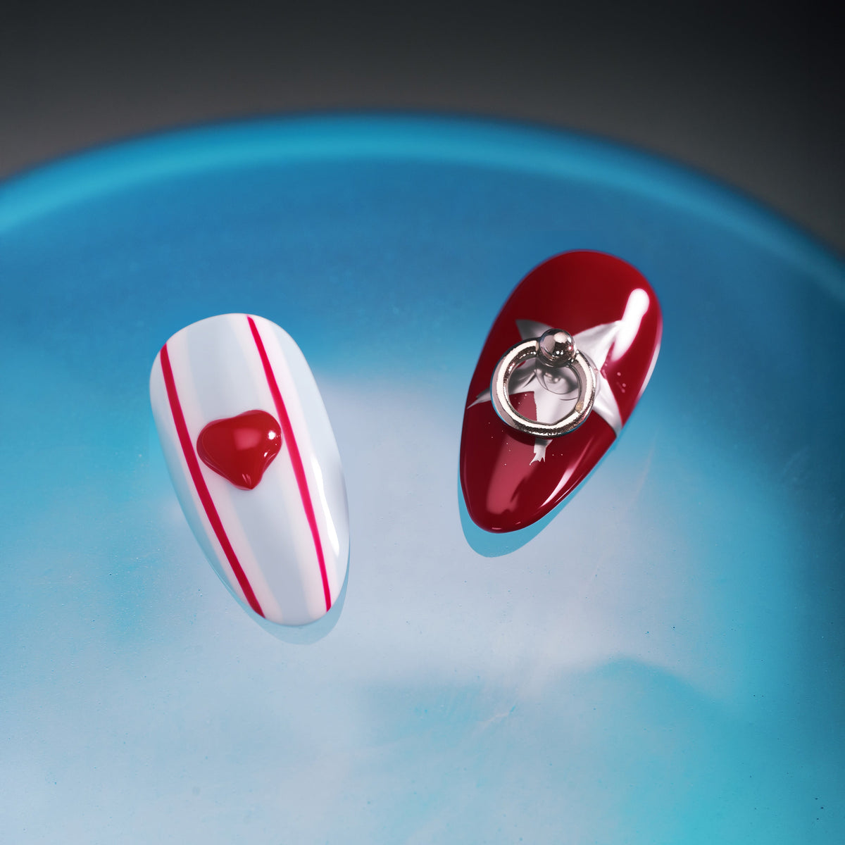 Modern heart press on nails with glossy red and metallic details. Trendy, reusable and eye-catching.