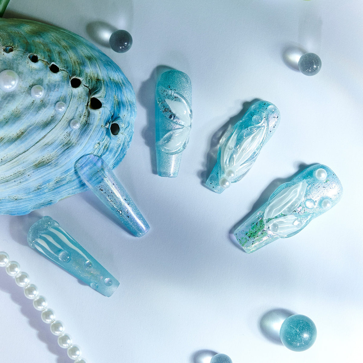 Ice Sea Fairy press-on nails with blue gradient, pearl accents, and 3D ocean-inspired textures