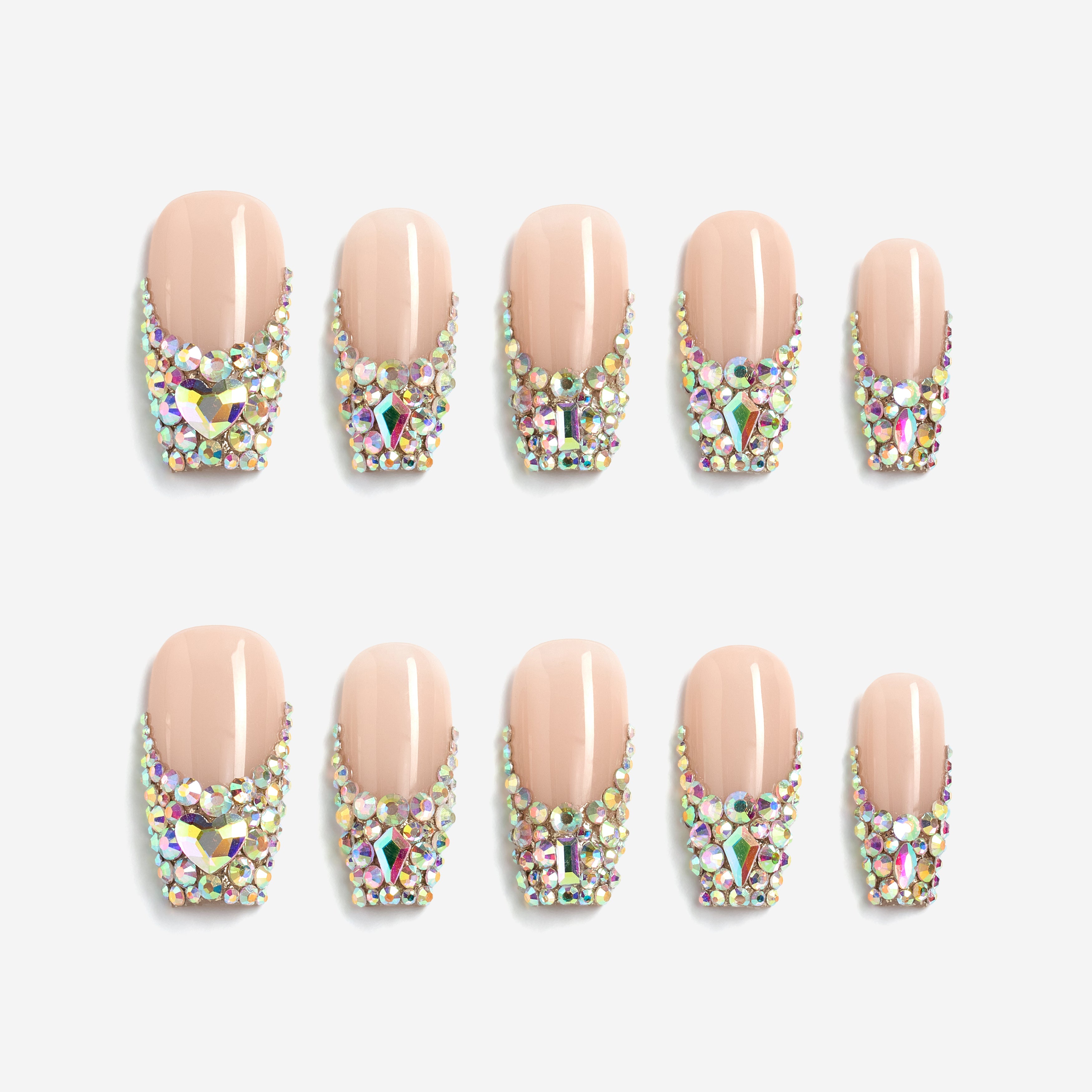 Luxury nude pink press on nails with oversized iridescent crystals and rhinestone detailing. Glamorous and reusable.