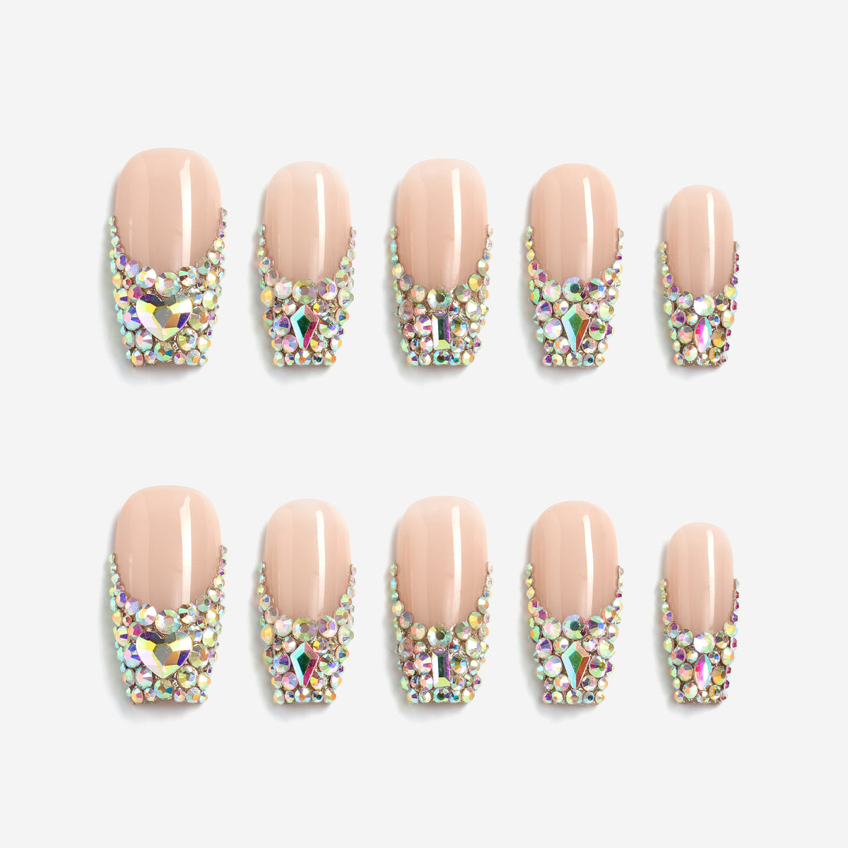 Luxury nude pink press on nails with oversized iridescent crystals and rhinestone detailing. Glamorous and reusable.