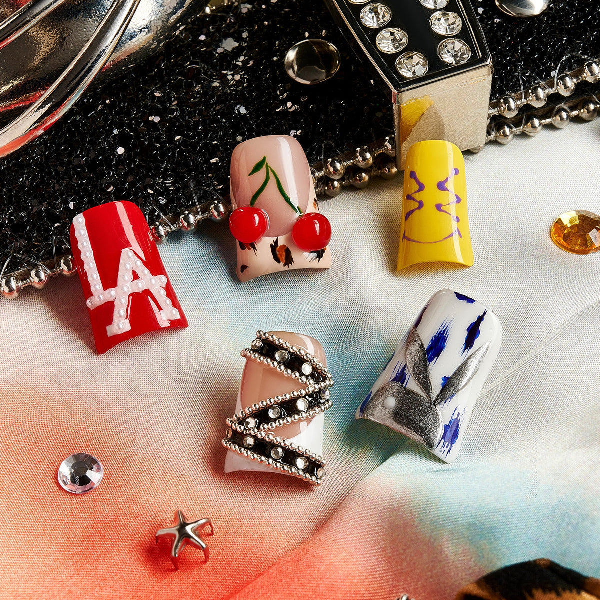 Modern Artbeat press on nails with mixed graffiti, pearls, symbols, and playful icons