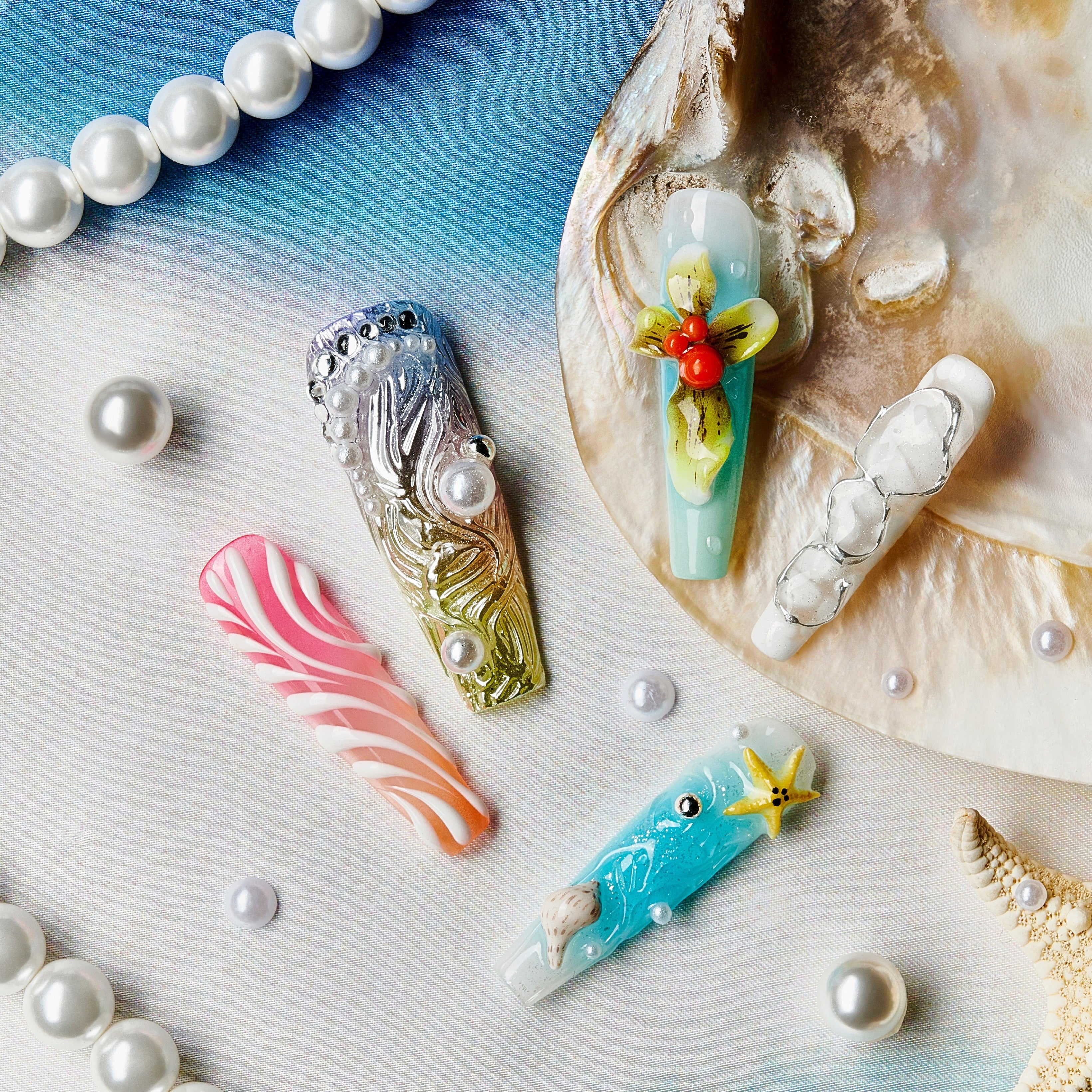 Oceanic Enchantment press-on nails with seashell designs, starfish charms, coral accents, and pearl decorations