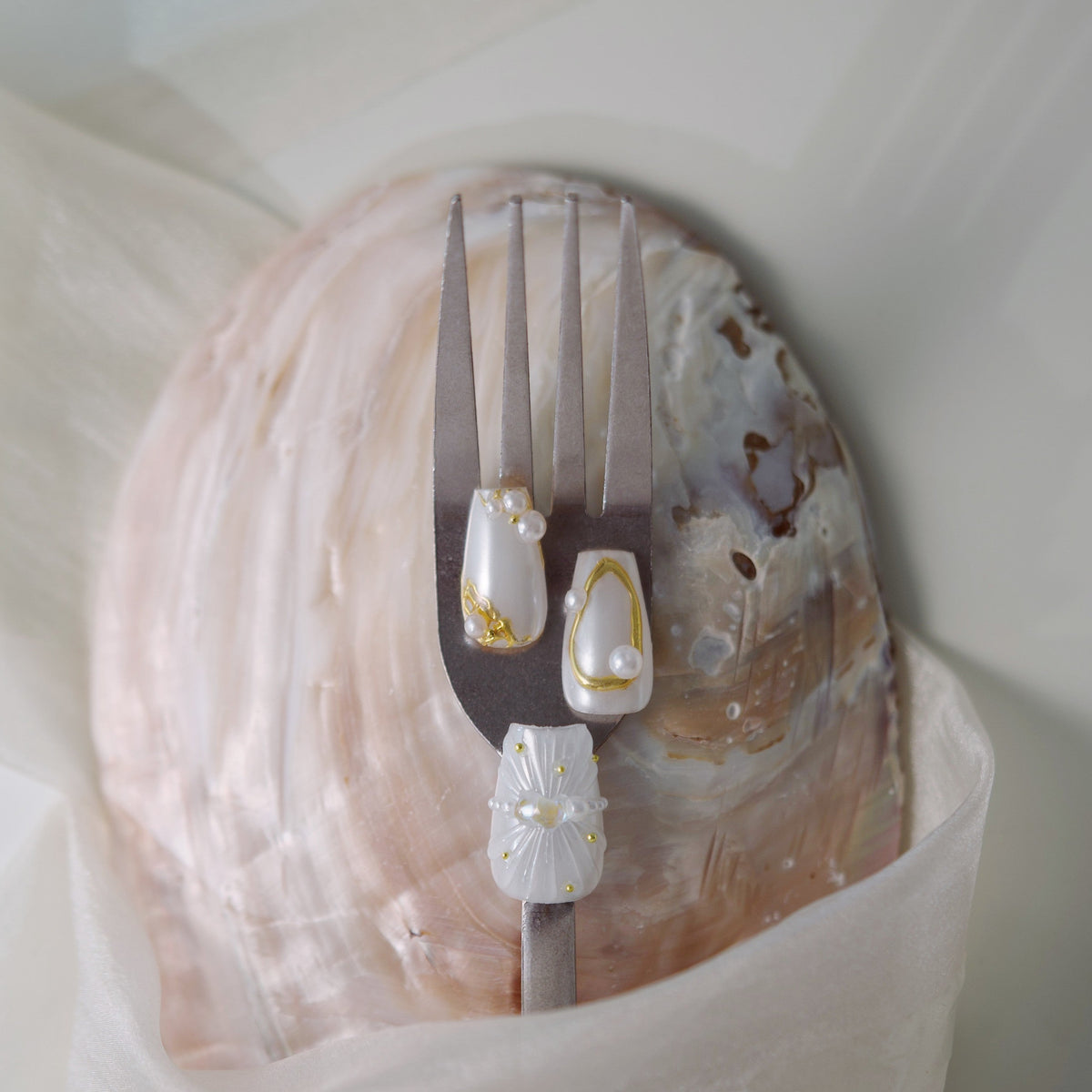 Pink ombre glitter press on nails with opalescent crystal detailing. Romantic sparkle and reusable design.